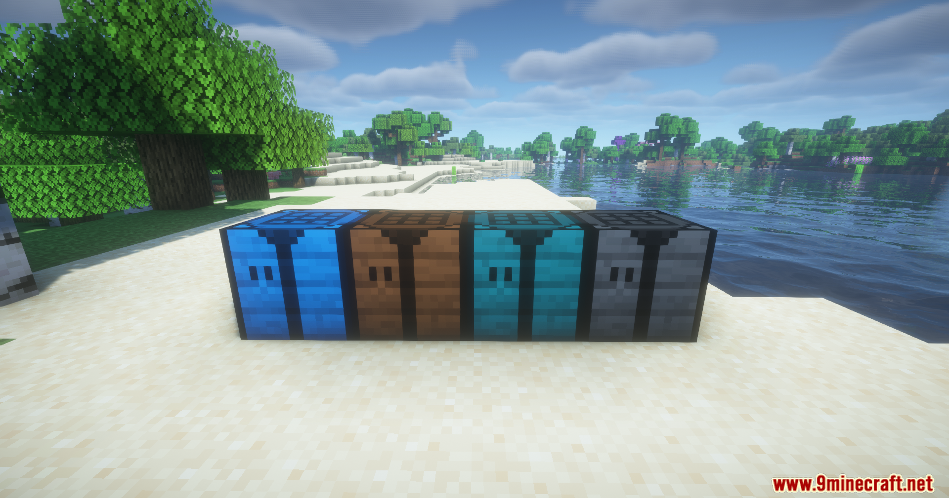 Four colorful crafting tables placed in a row on a sandy beach