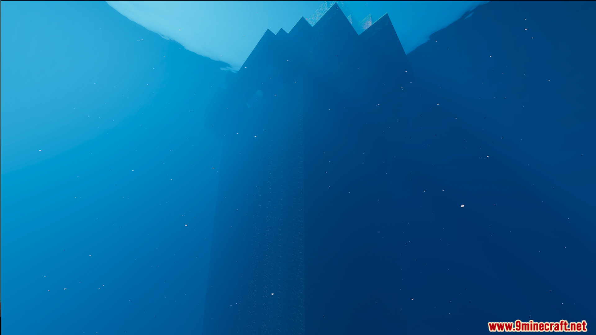 A dark underwater view of a large structure beneath the deep ocean surface