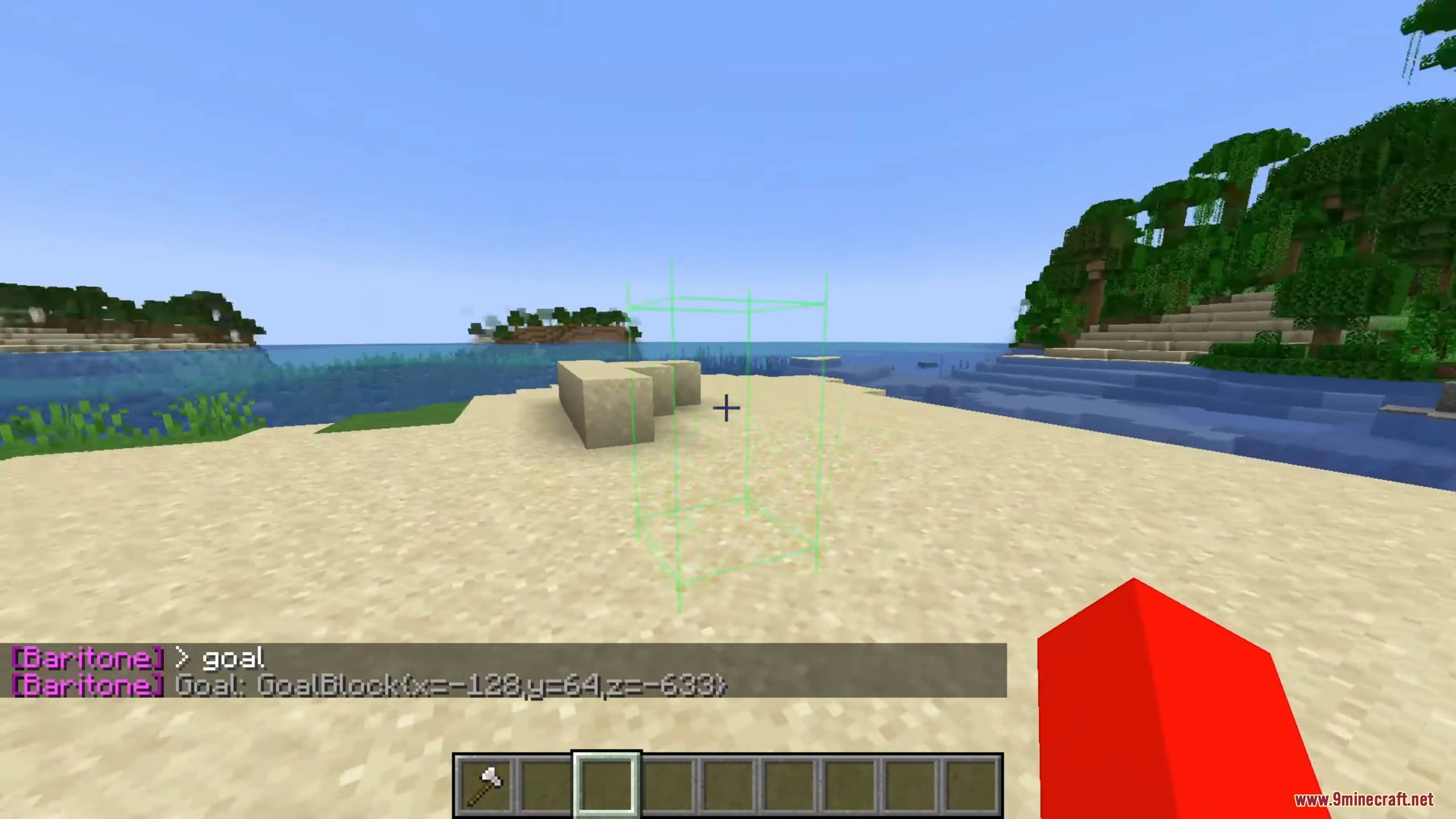 A green wireframe box marks the target goal on a sandy beach.
