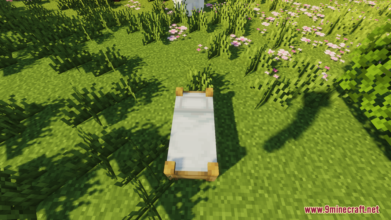 Bee's Cozier Beds Resource Pack Screenshot 1 A white bed with detailed wooden legs placed on a flowery field