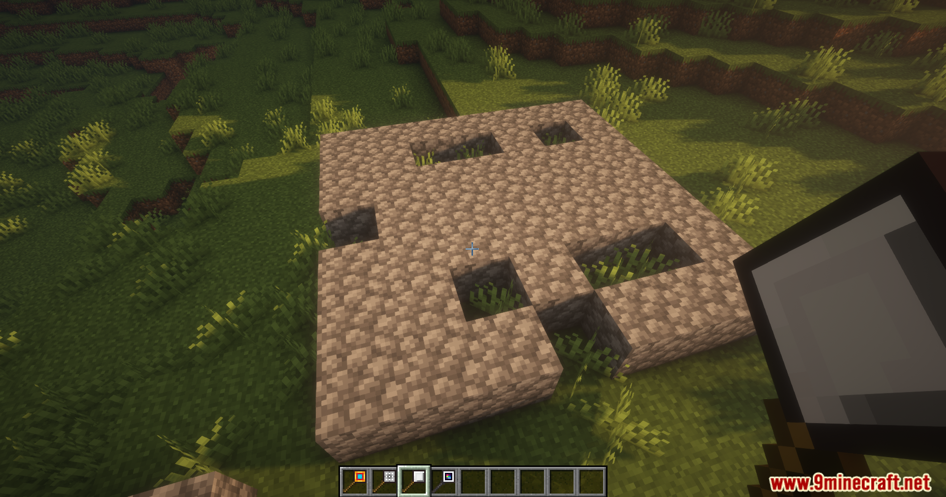 Better Blockz Mod Screenshot 4 Player using a special tool to modify patterns on a cobblestone platform