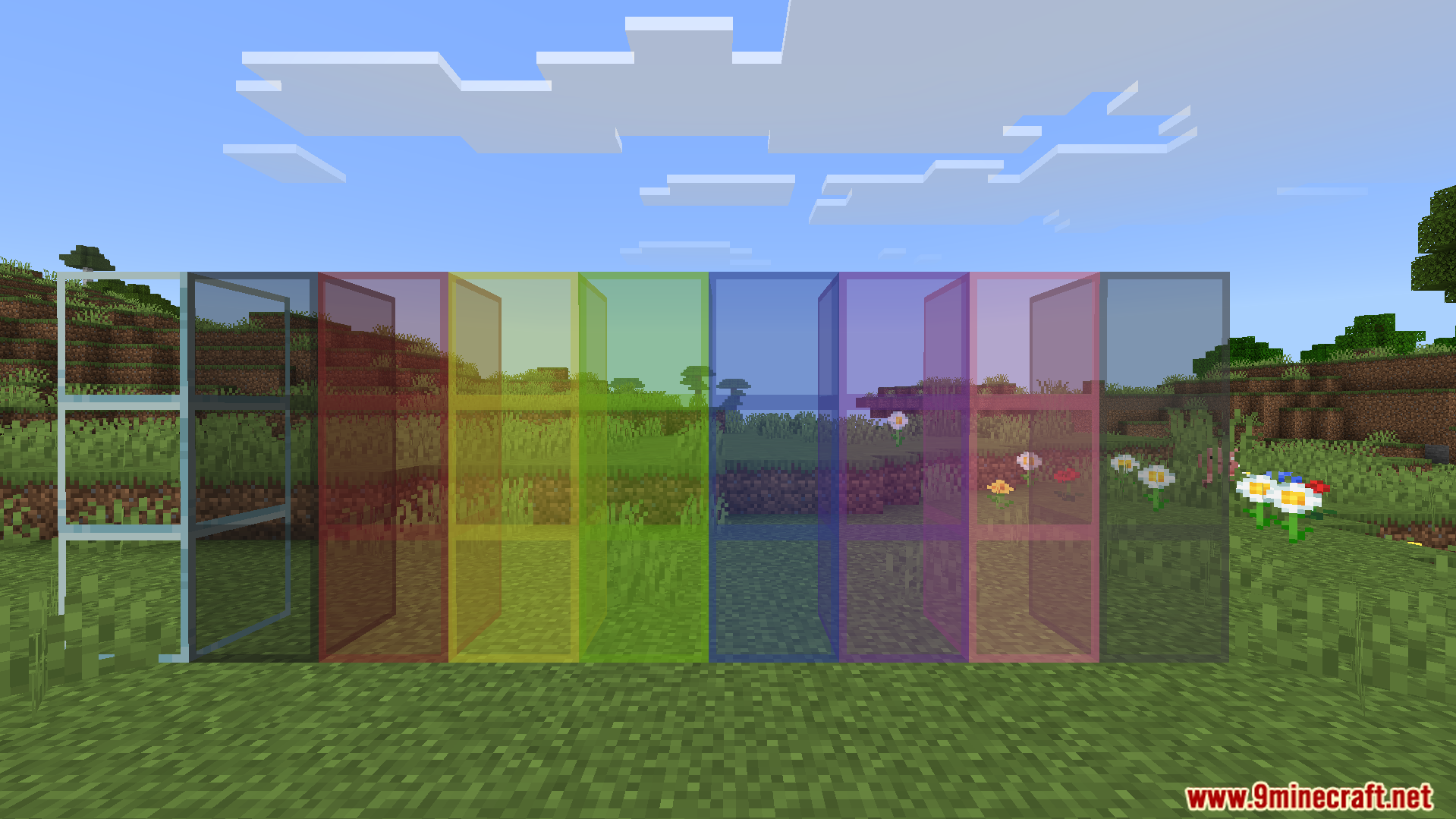 Showcase of transparent colored glass blocks without edge lines in a grassy field