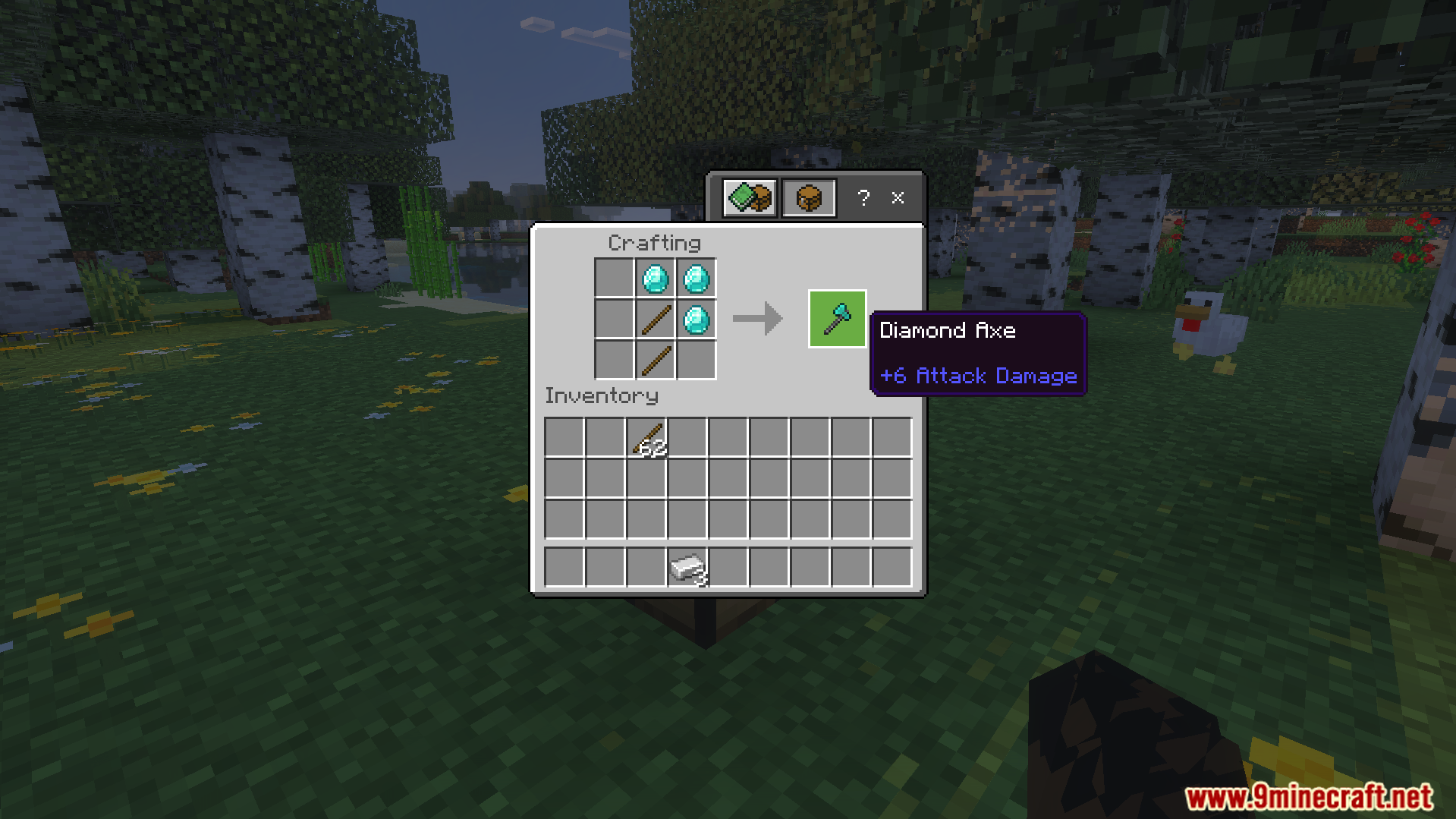 Player crafting a diamond axe using sticks and diamonds in a crafting table