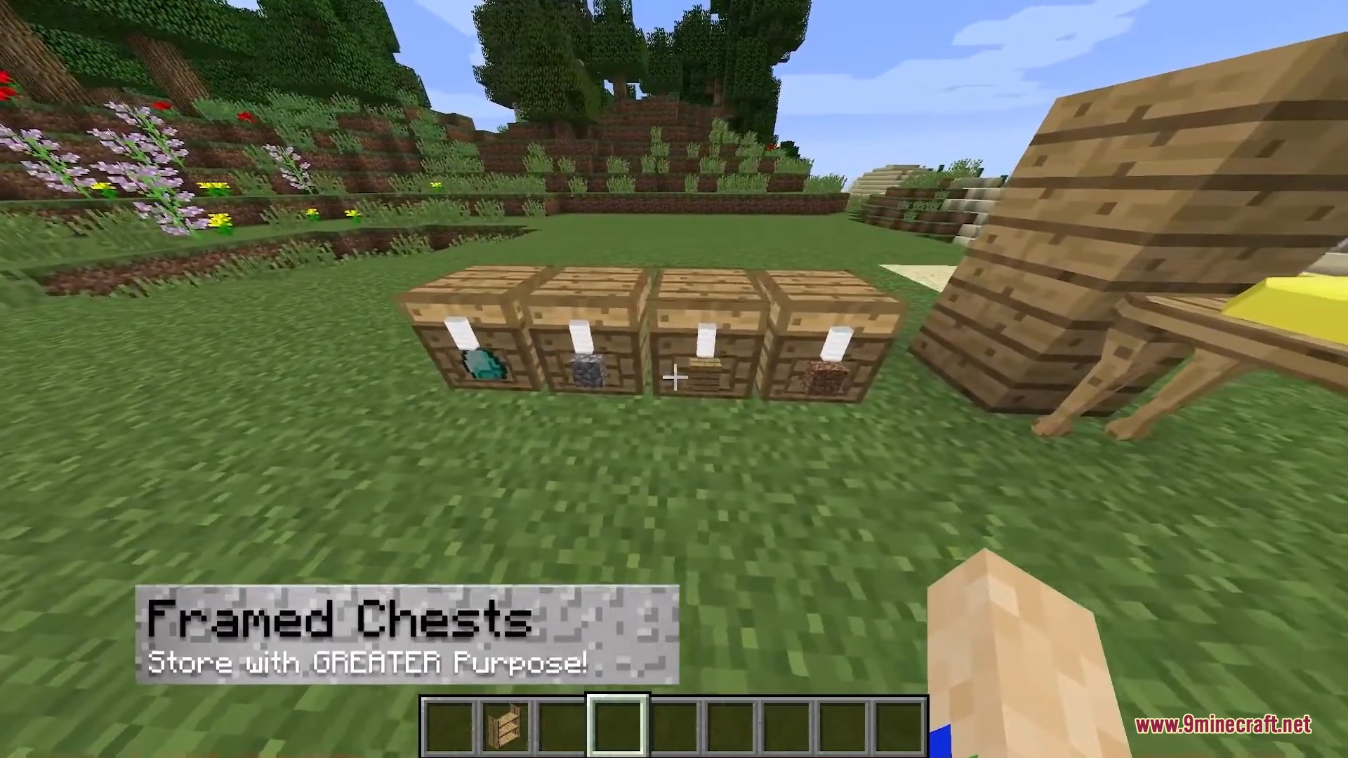 Four wooden chests with item frames displaying different materials in a field