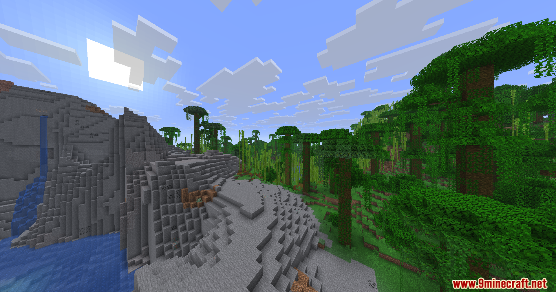 A tall rocky mountain overlooks a dense jungle and bamboo forest