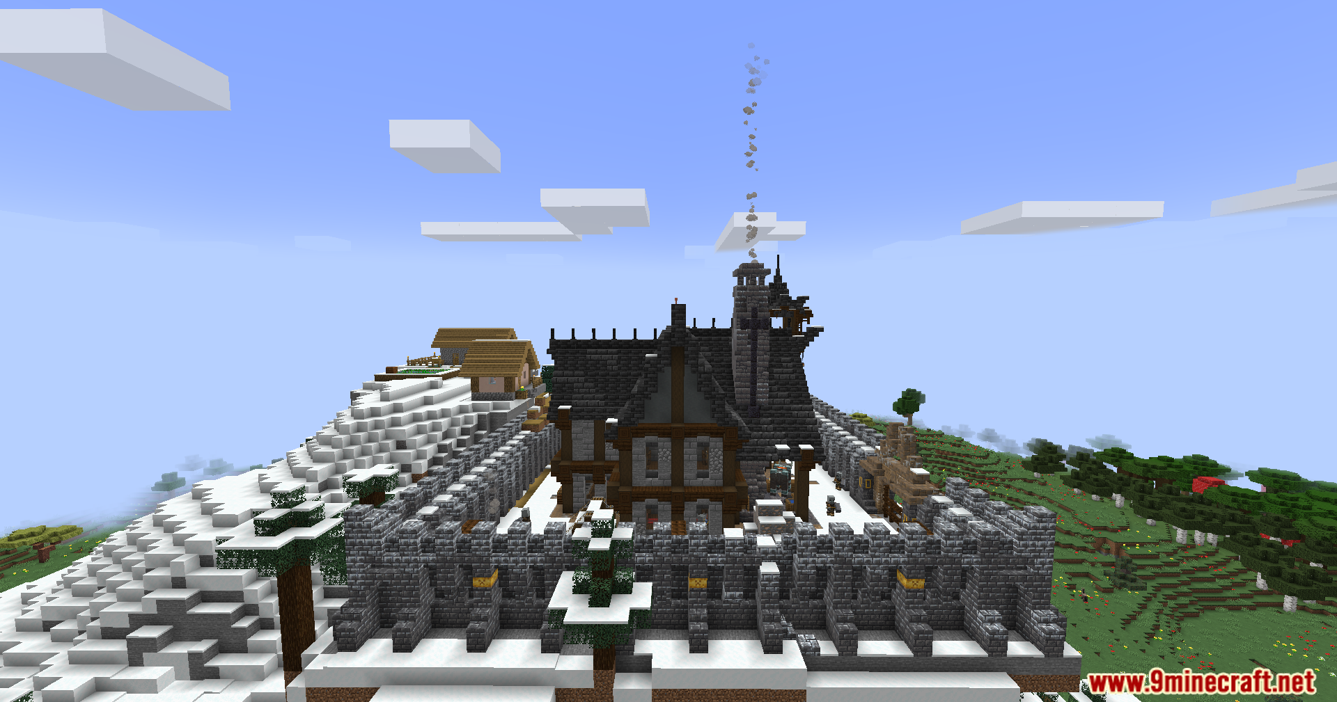 A large fortified stone structure with a smoking chimney on a snowy hill