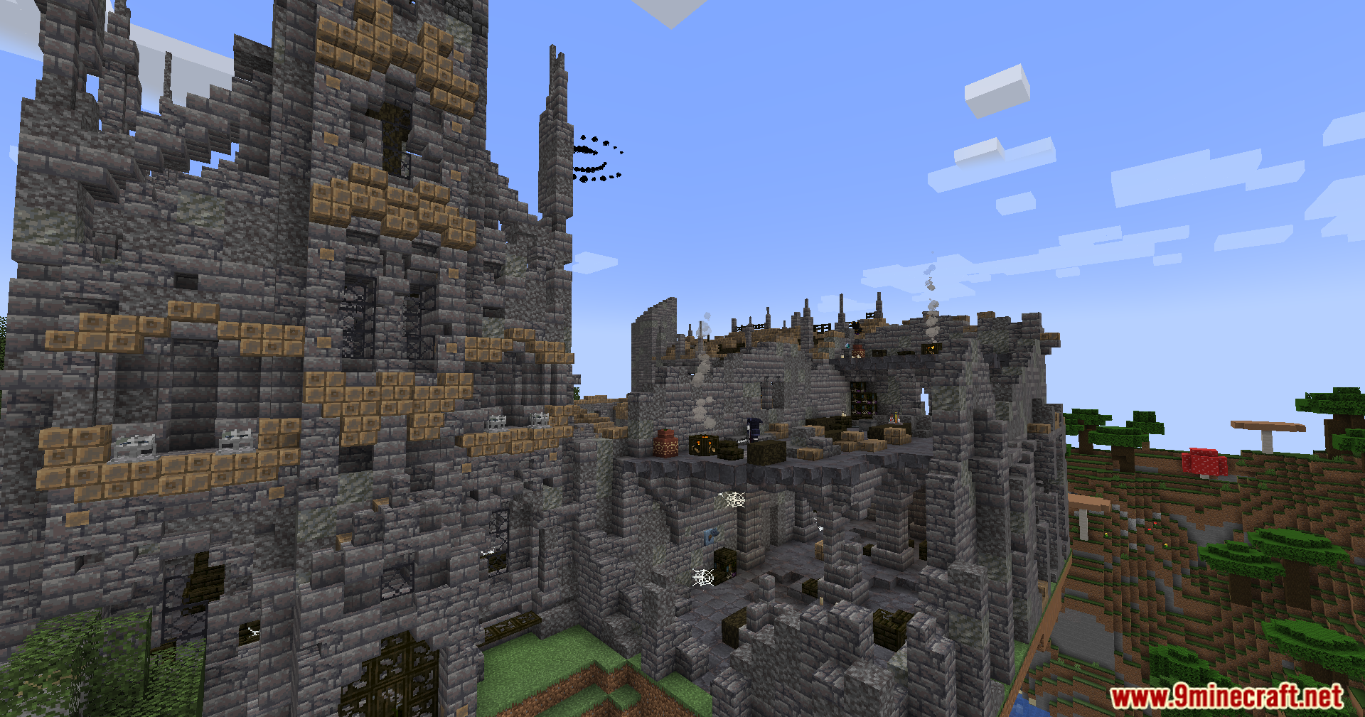 A large ruined stone cathedral standing in a grassy Minecraft landscape