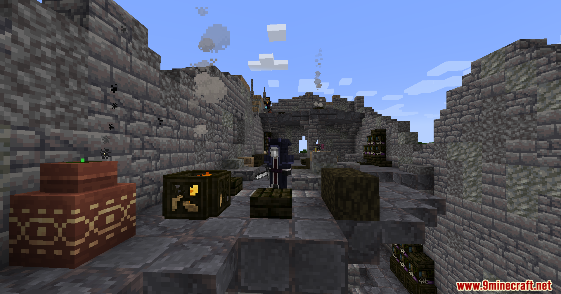 A player in dark robes explores the interior of a ruined stone building