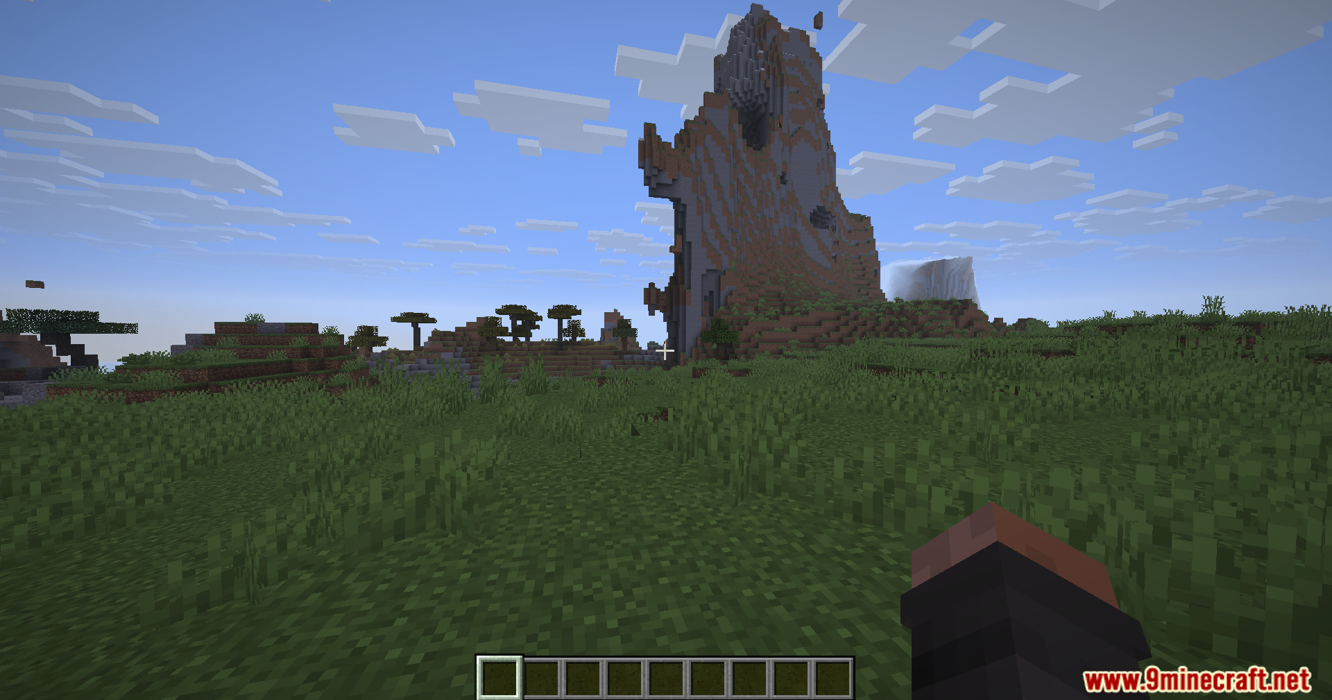 Brightness Plus Mod Screenshot 2 A scenic Minecraft landscape featuring a tall mountain under a blue sky