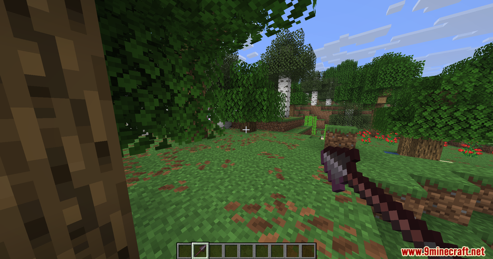 Carpet Pvp Practice Mod Screenshot 9 Player holding a dark purple axe while standing in a dense forest