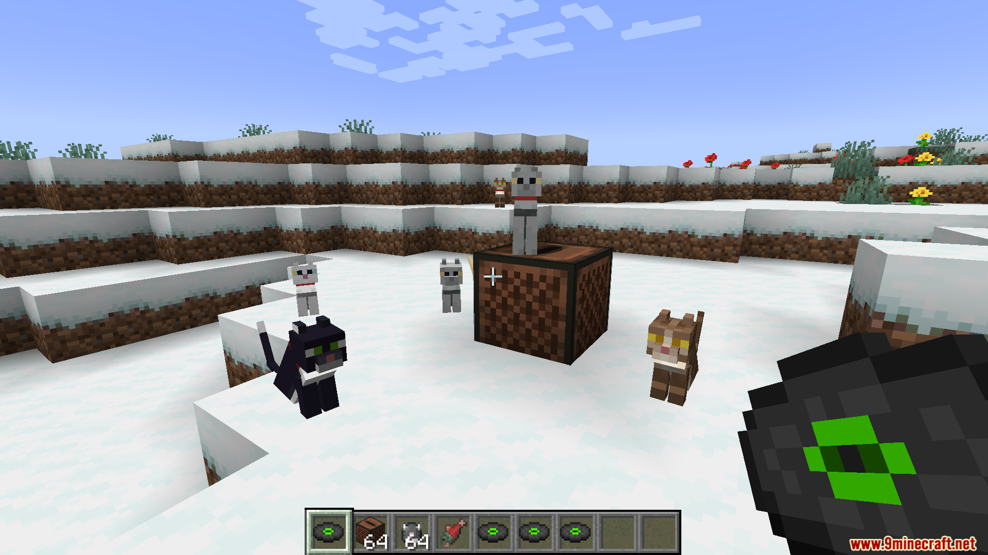 Cat Jam Mod Screenshot 1 Player holding a music disc while cats dance around a jukebox in snow