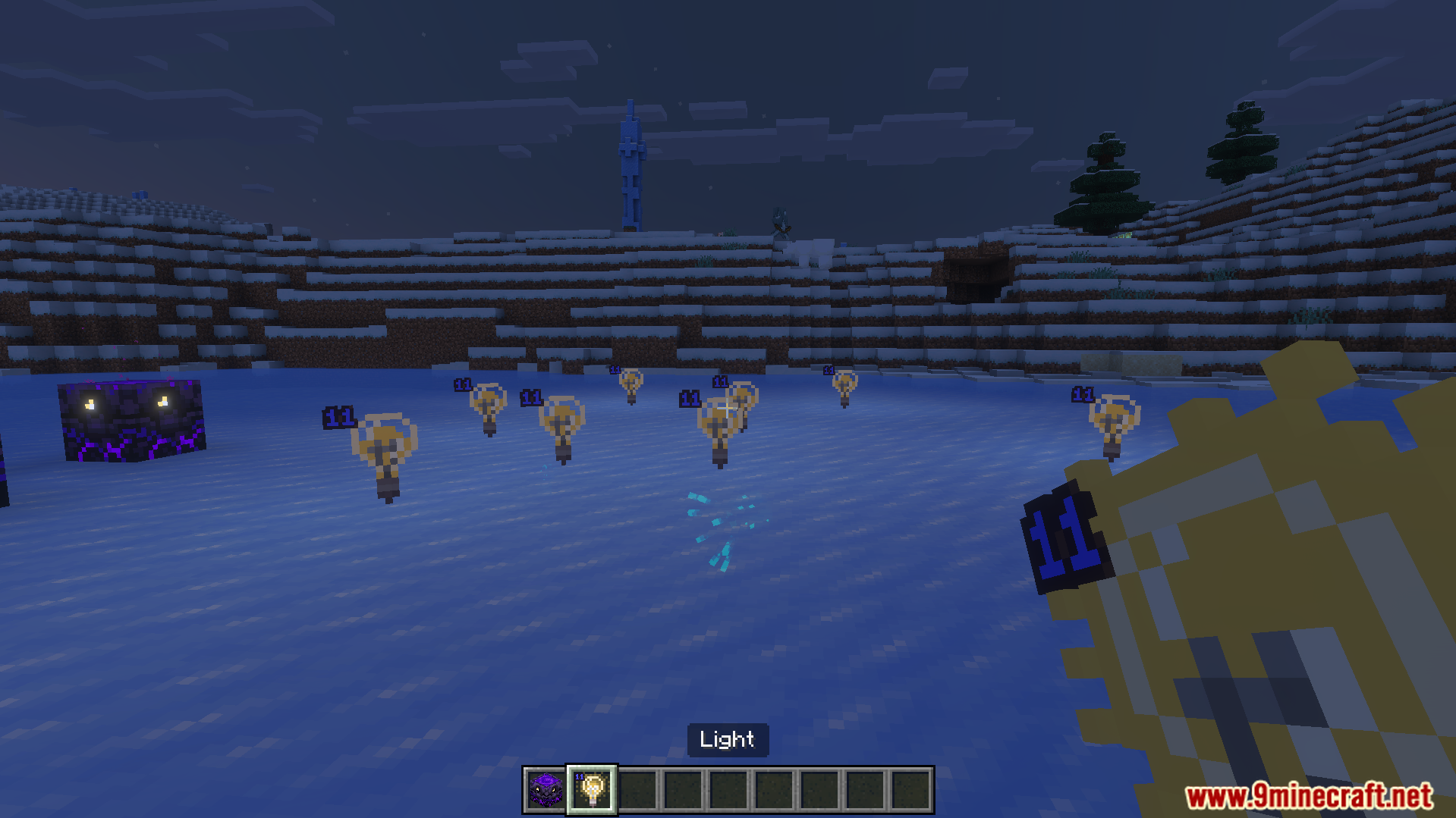 Player holding a light block item with numbered light icons in world
