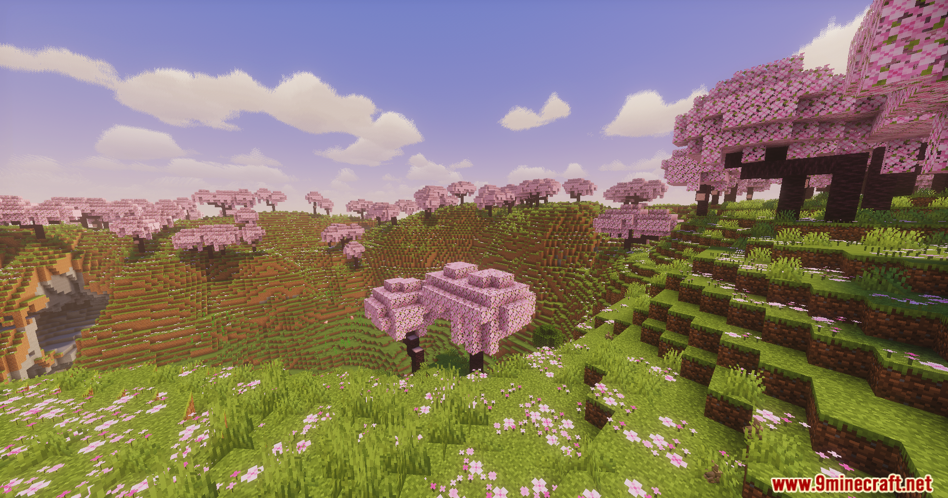 Vibrant cherry blossom biome with rolling hills under a clear blue sky
