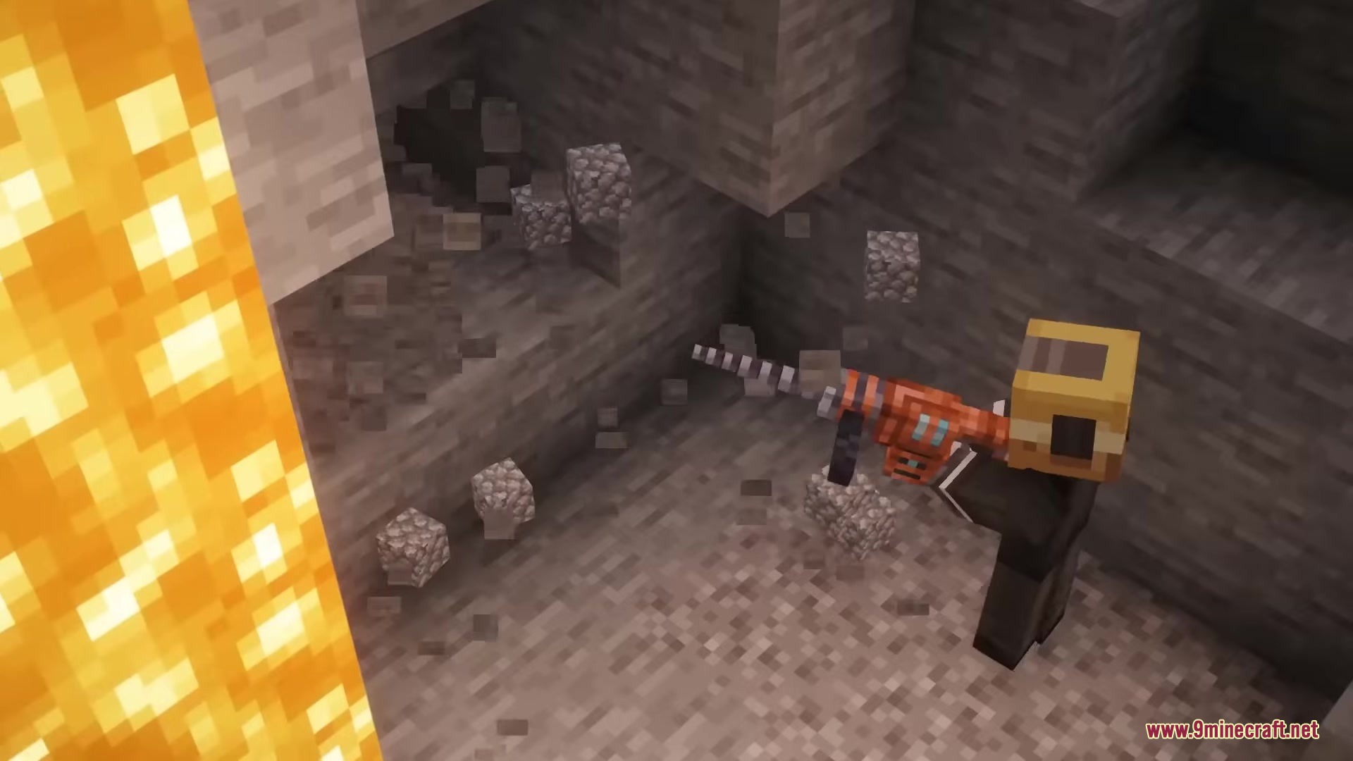 A player uses a futuristic alien drill to mine stone in a cave