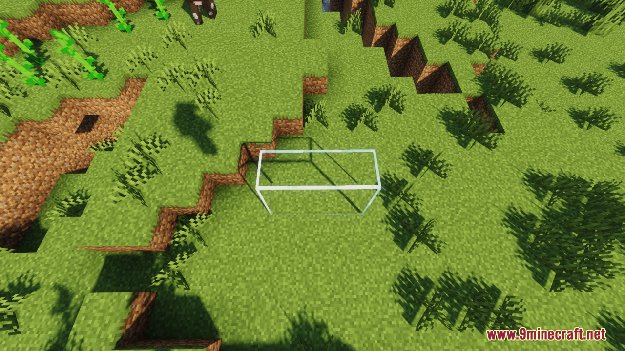 Overhead view of a clear glass pane casting a shadow on grass