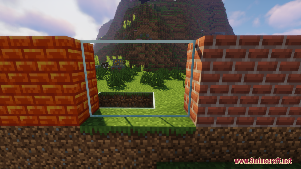 Viewing a mountain through a large clear glass window between brick walls