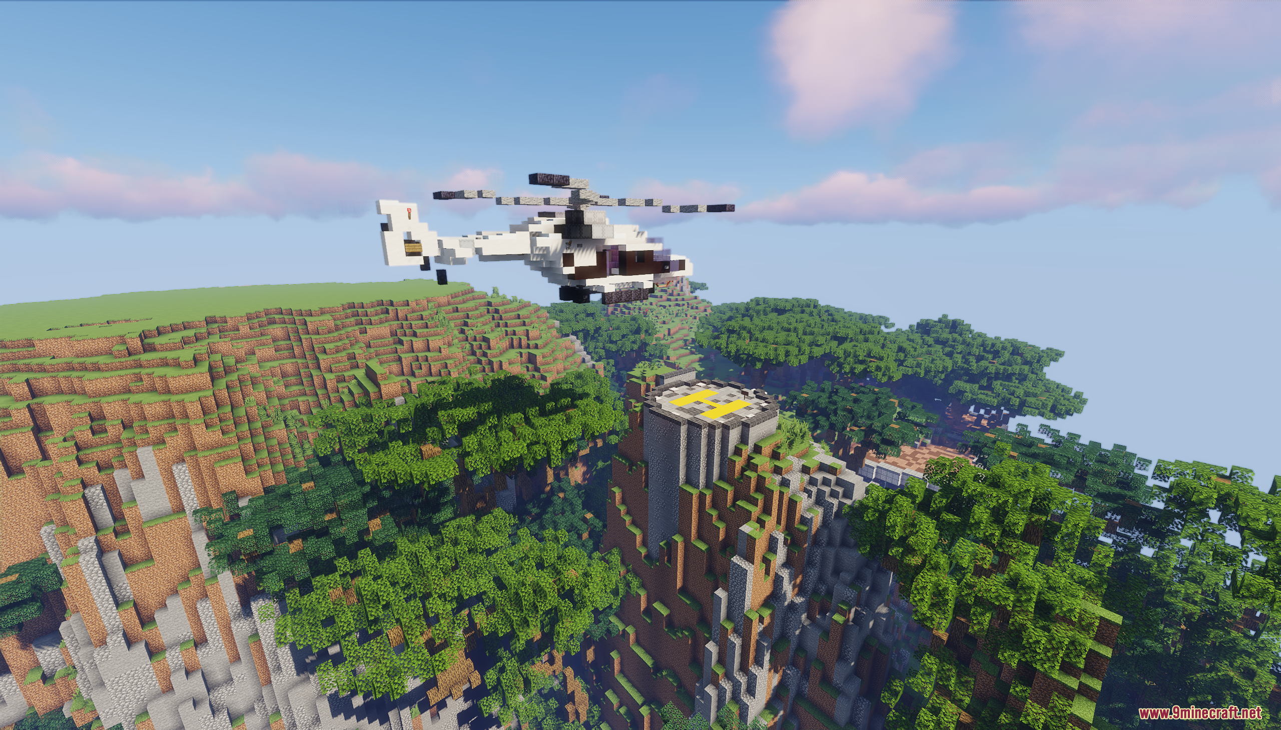 A white helicopter flying towards a circular helipad on a steep mountain cliff