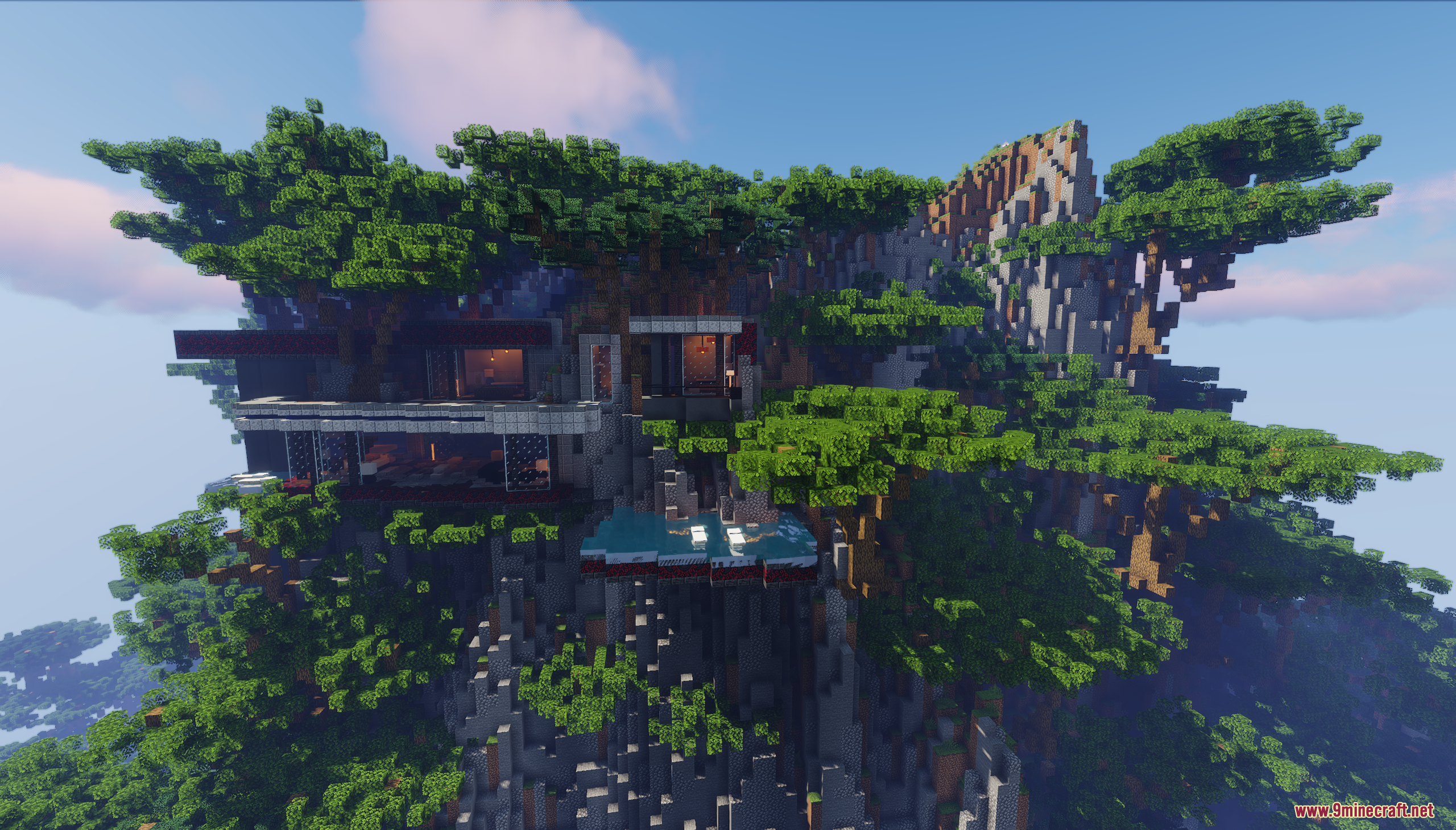 A large modern mansion built into a cliffside surrounded by lush green trees