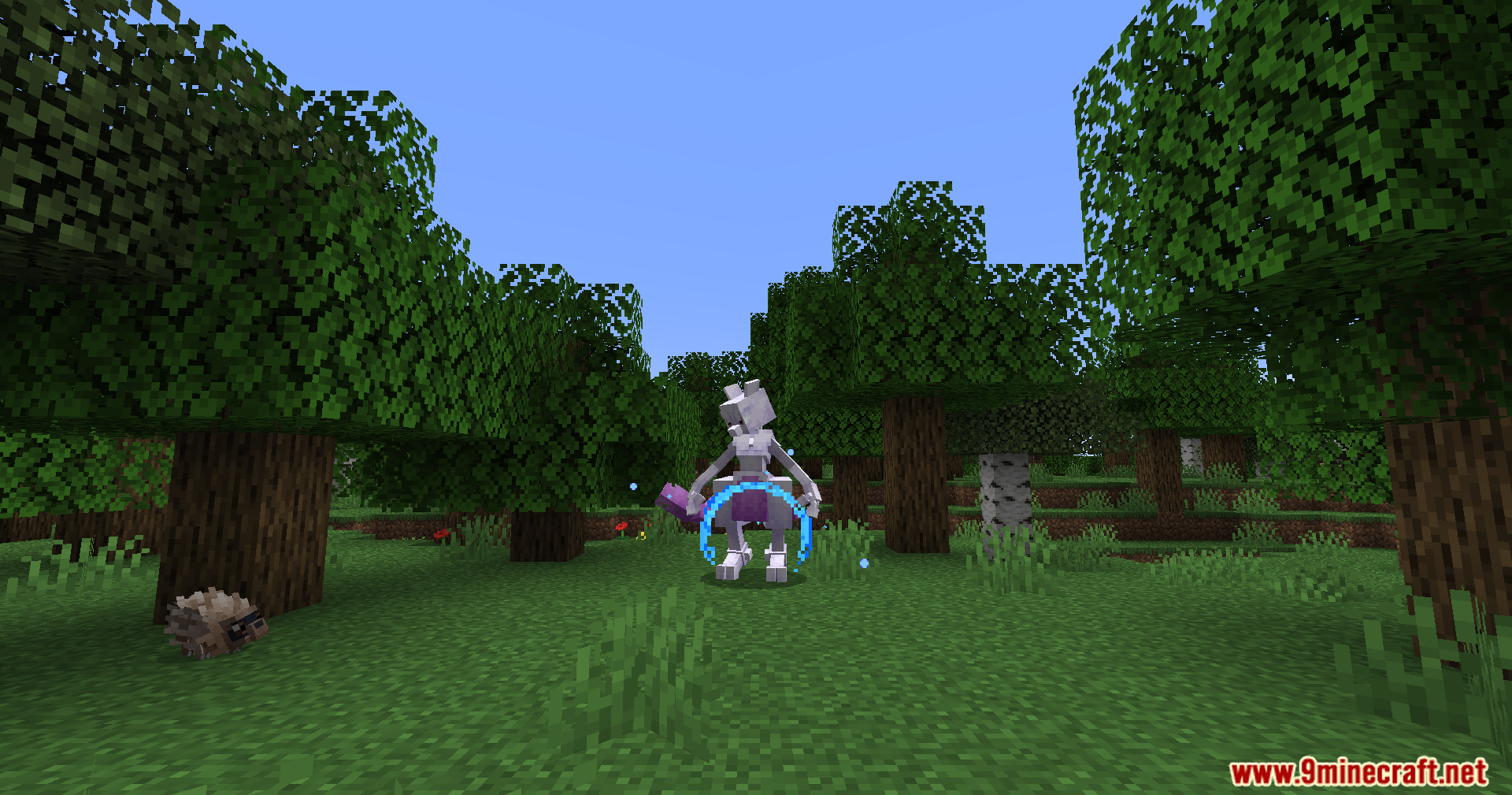 Mewtwo stands in a forest with a glowing blue circular particle effect