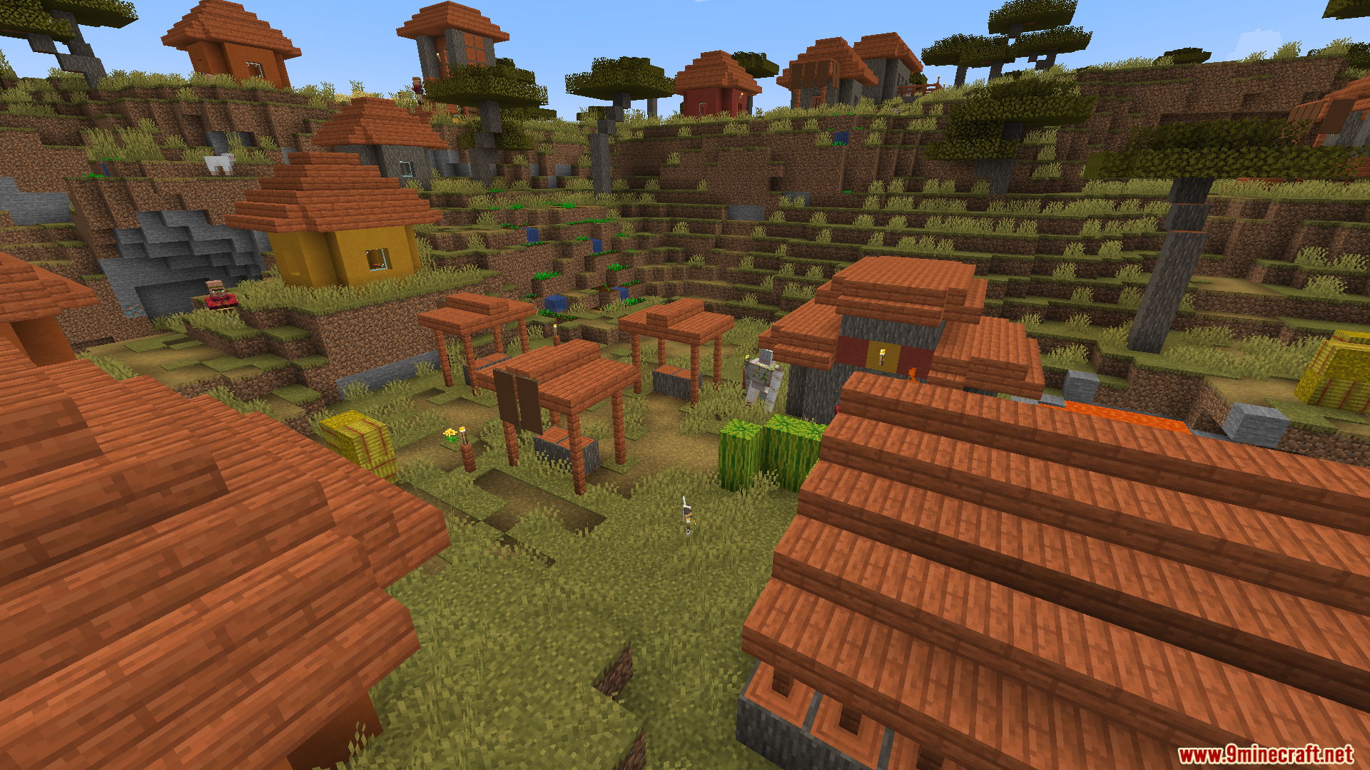 Cobblemon Villager Overhaul Mod Screenshot 8 A scenic view of a savanna village with various houses and stalls