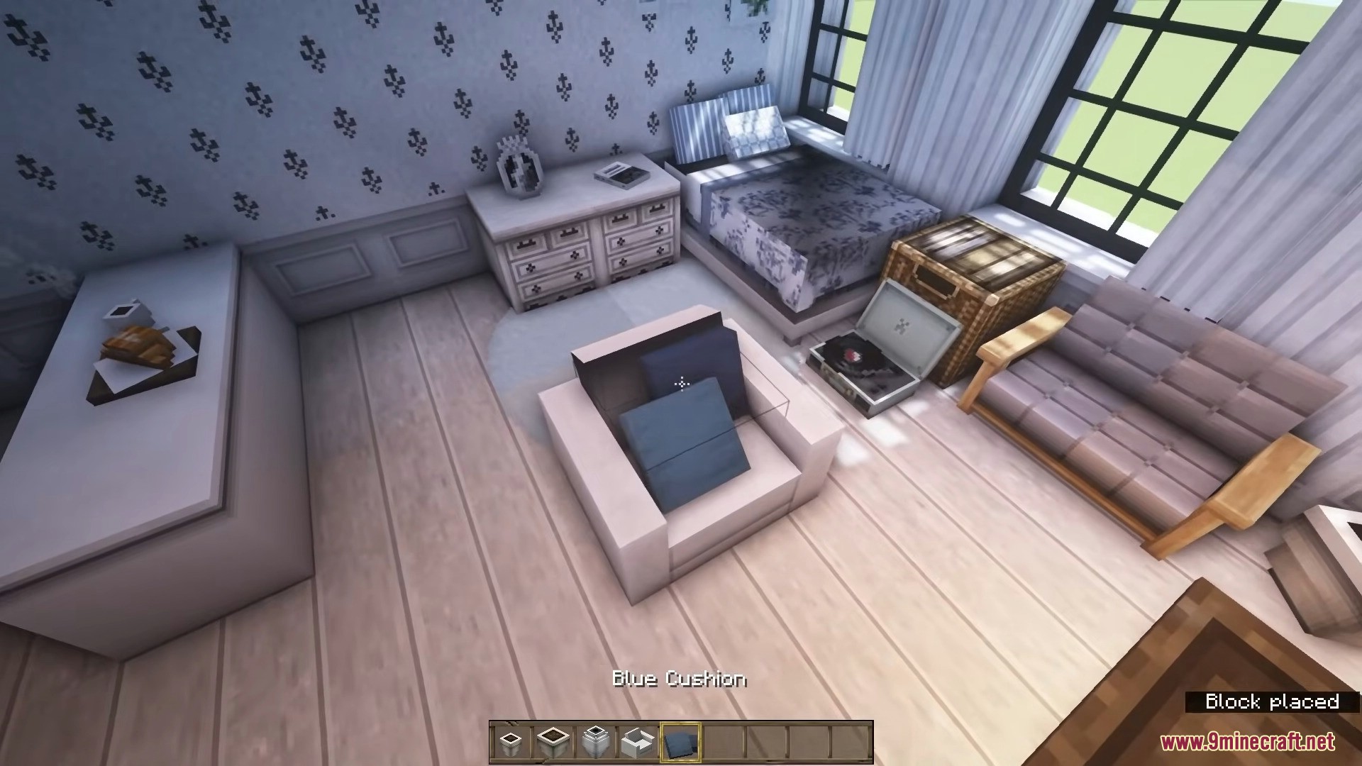 A beautifully furnished bedroom with a record player and comfortable seating options