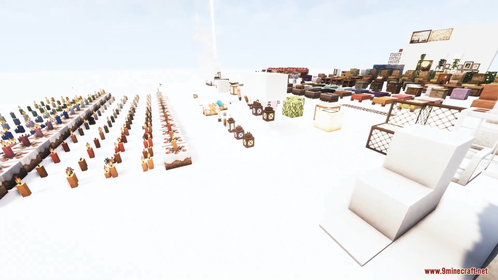 A wide selection of detailed candles and lanterns displayed on a white floor.