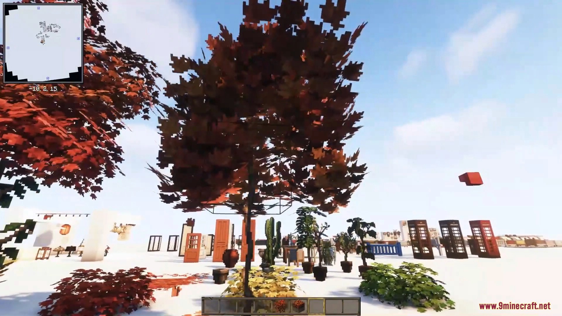 Beautiful autumn trees and potted plants stand near classic red telephone booths.