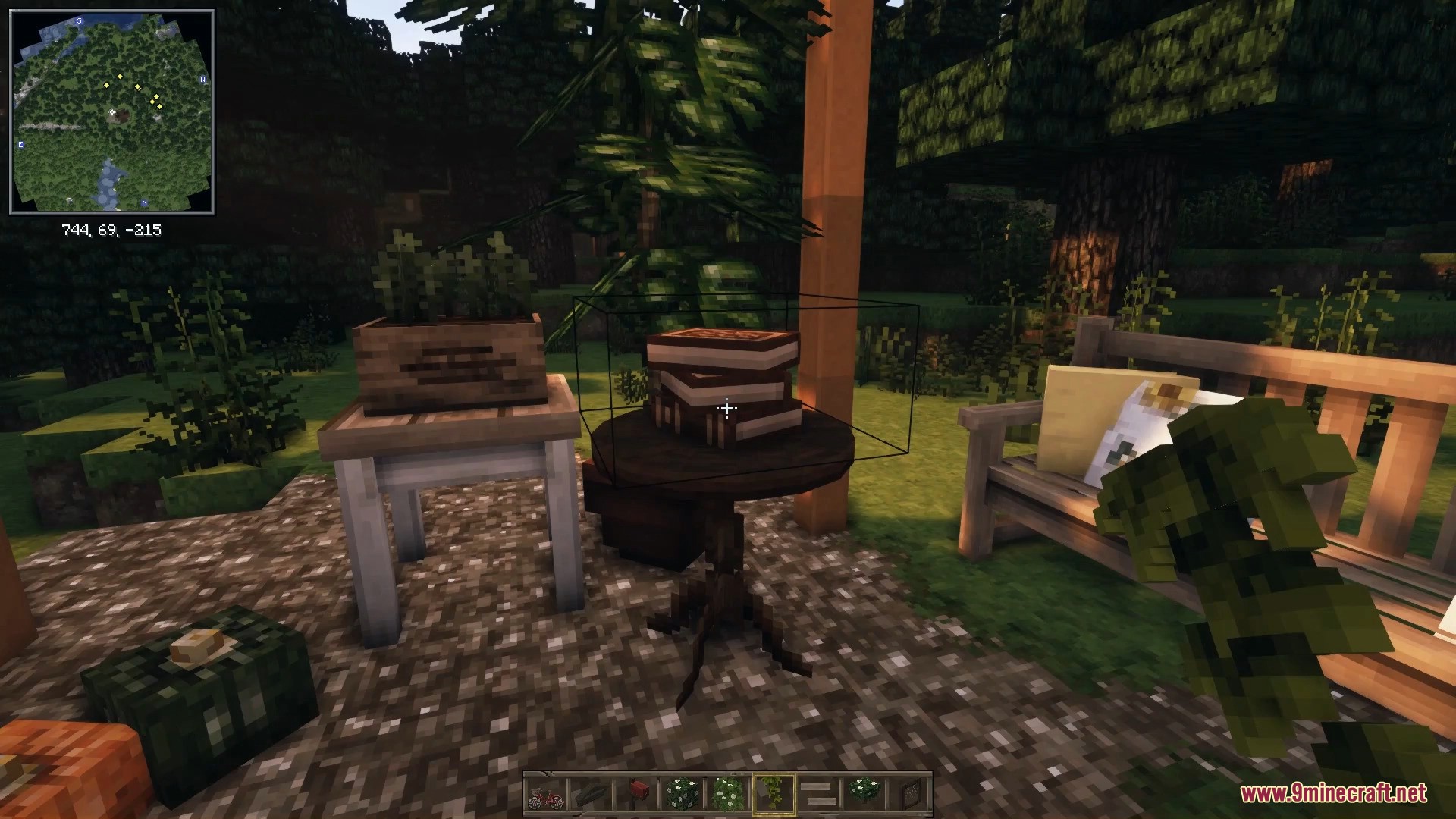 A peaceful garden seating area with a wooden bench, small table, and books.