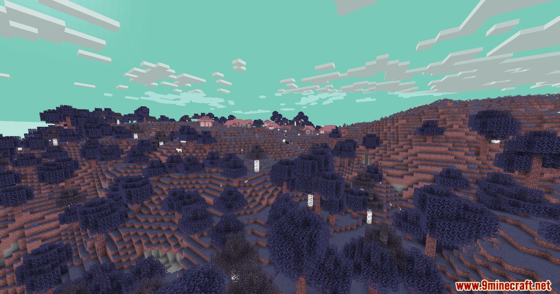 A distant village nestled among purple trees under a bright teal sky