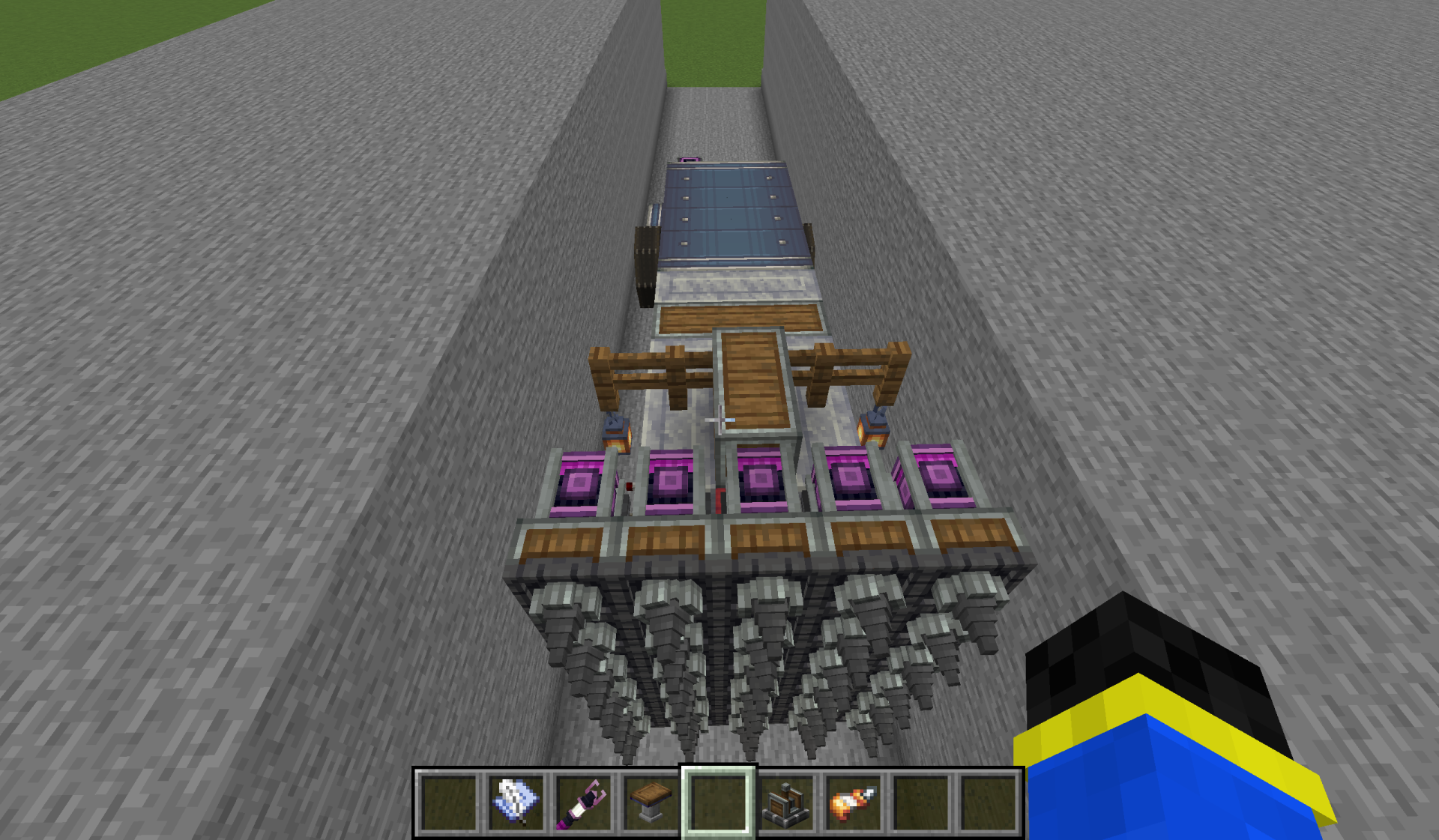 Large mechanical drill vehicle digging a wide trench through solid stone blocks