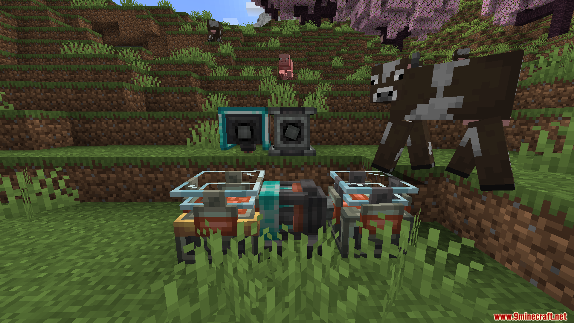 Electrical machines and components placed on grass next to a brown cow