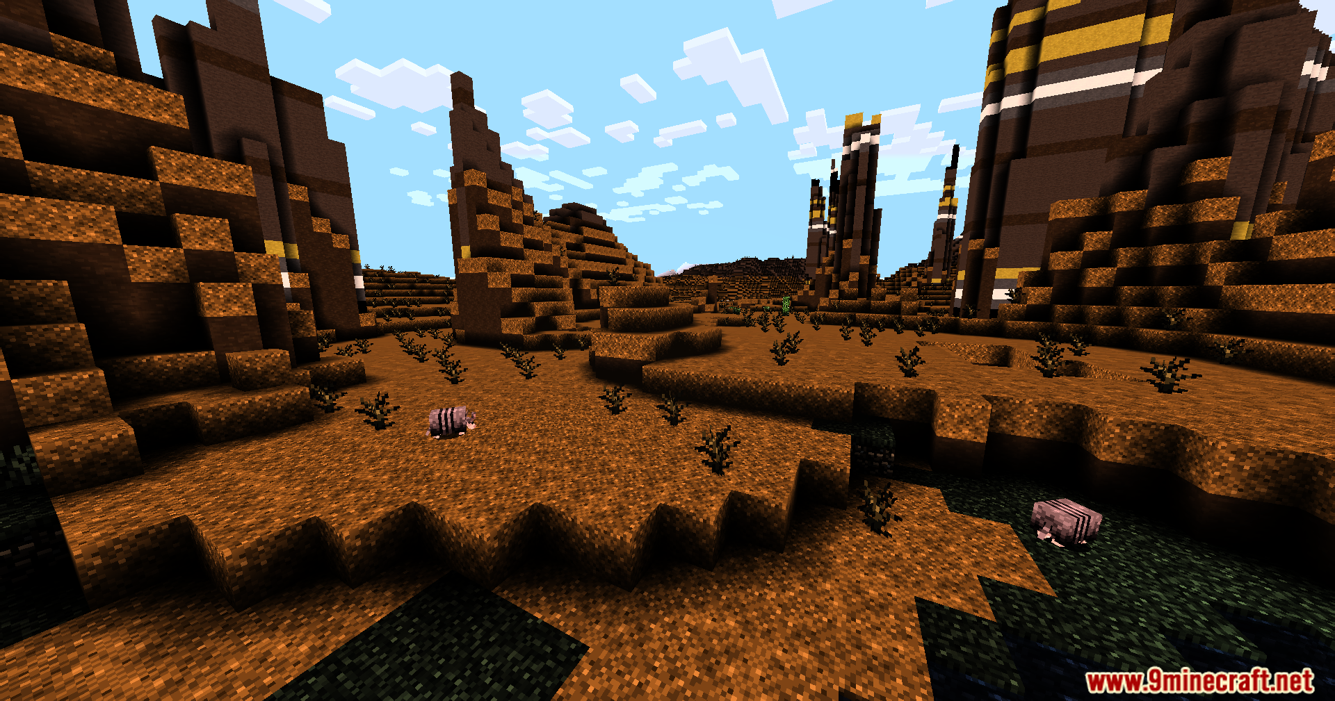 A brown desert landscape with spiky rock formations and small pig like mobs