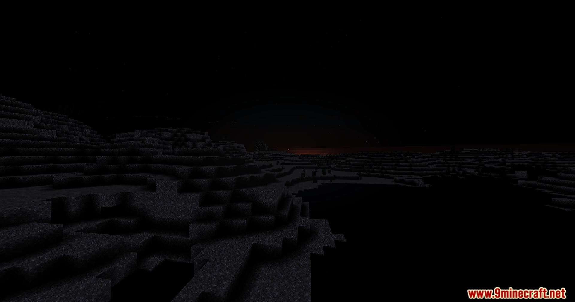 A hilly Minecraft landscape is completely hidden in total darkness at night