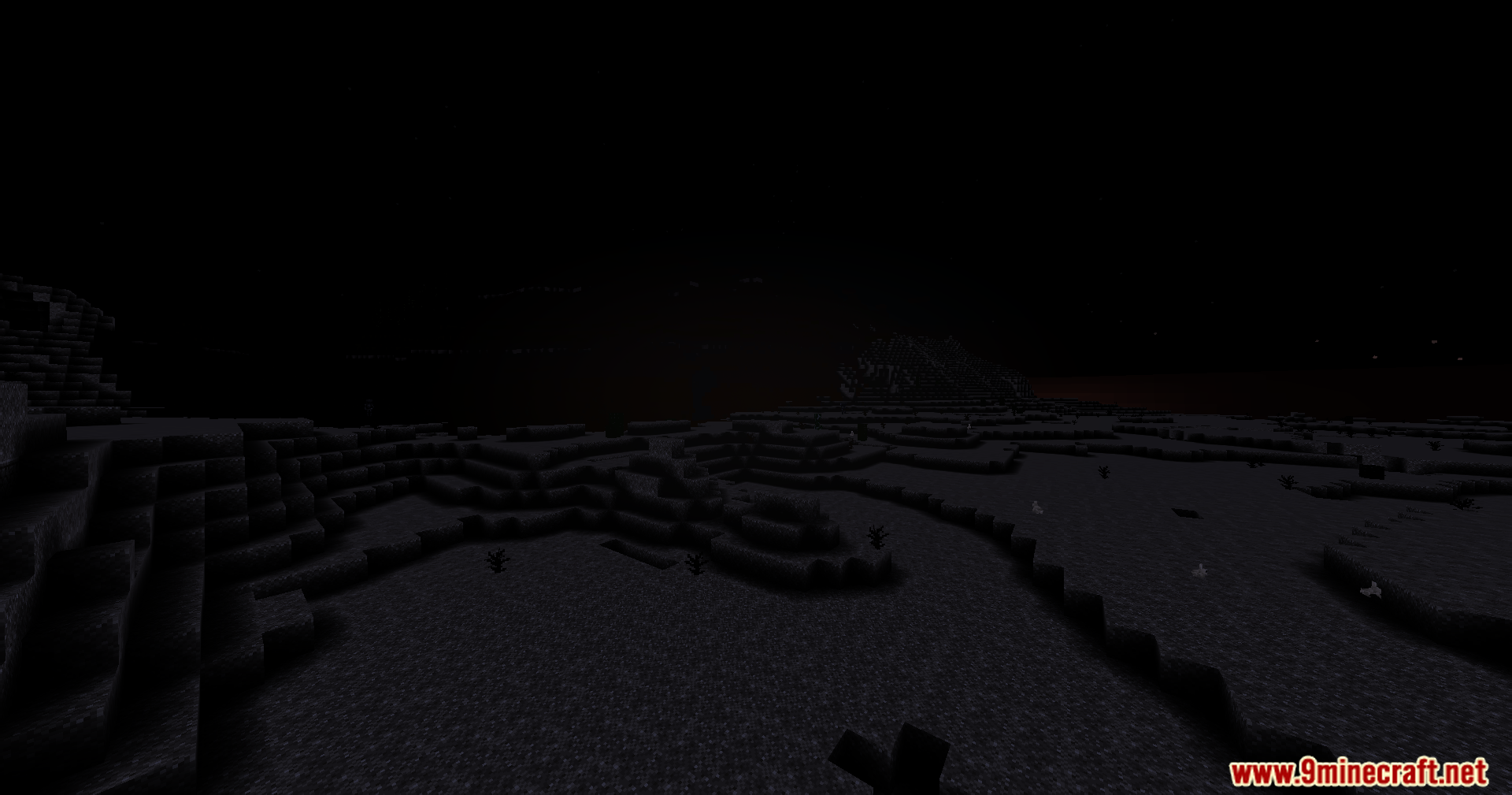 A vast dark Minecraft landscape under a pitch black night sky