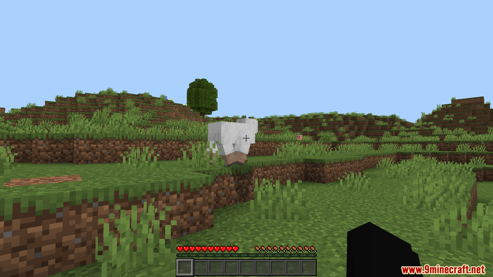 Dark Theme Texture Pack Screenshot 5 A white sheep stands on a grassy hill in a Minecraft world
