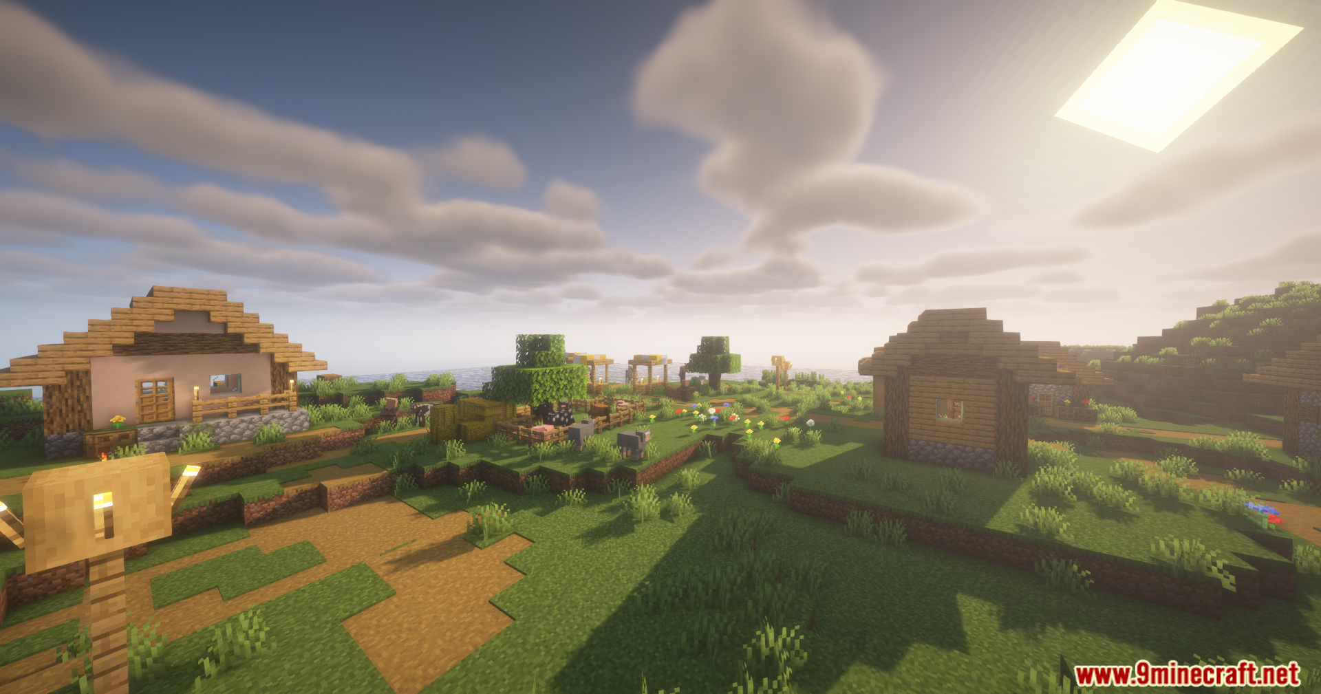 Disable Fog Mod Screenshot 4 Bright sunlight shines over a small village with wooden houses and farm animals