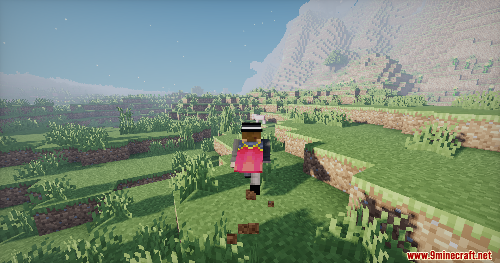 Doruk's Shaders Screenshot 3 A player wearing a pink cape runs through a sunny grassy field near mountains