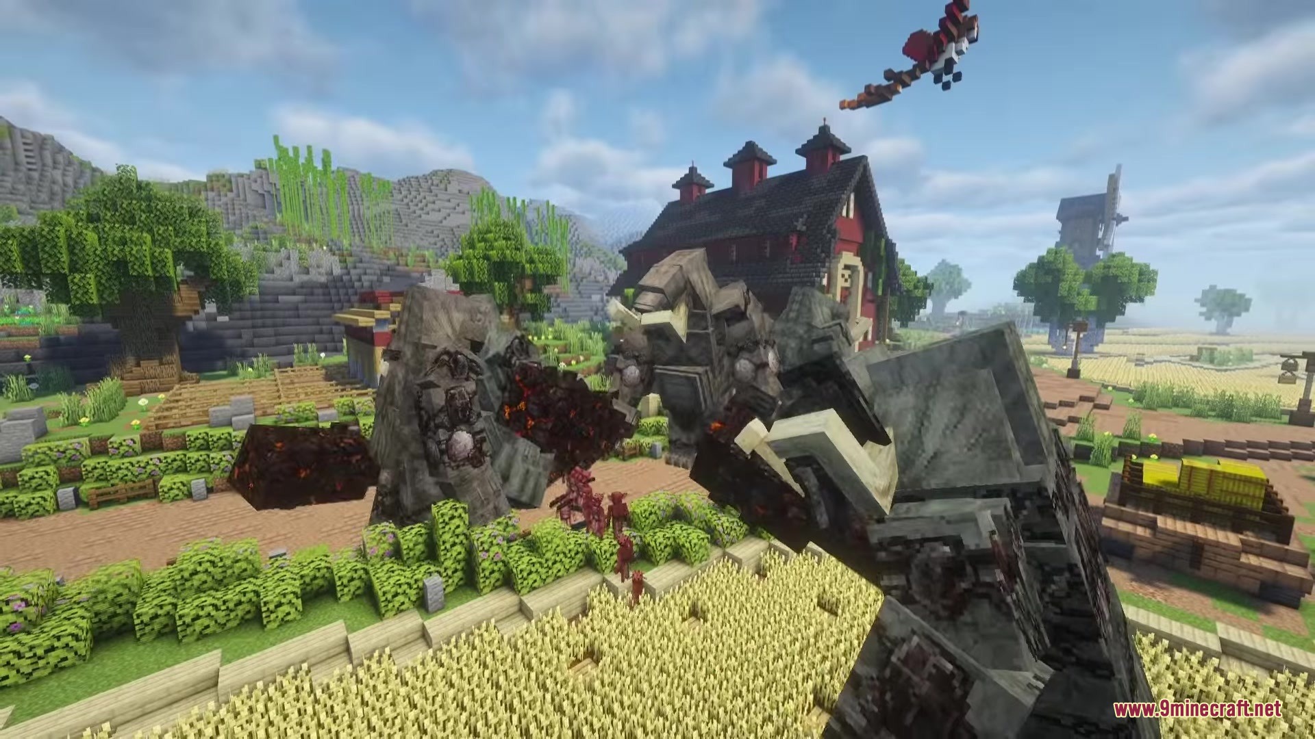 Giant stone monsters roam through a wheat field near a barn
