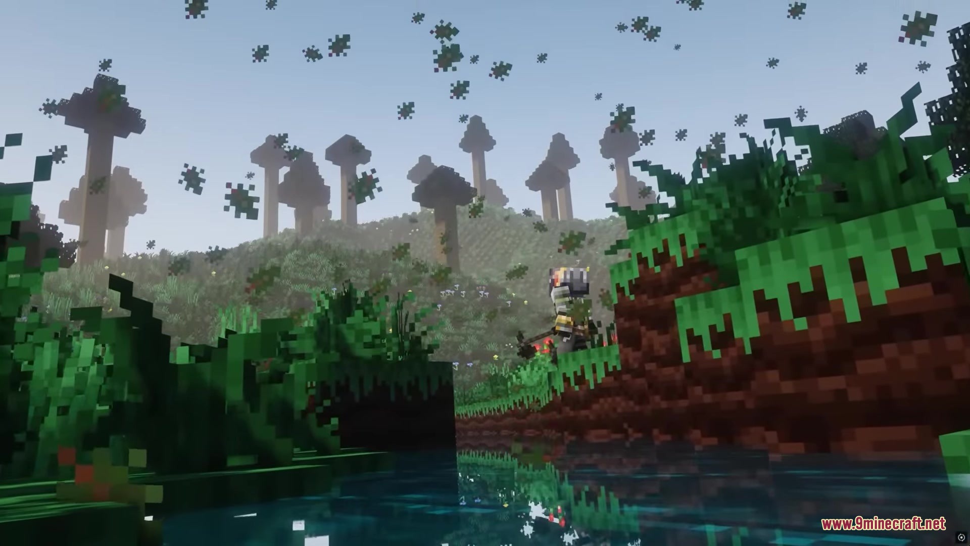 A player explores a hilly forest with tall trees and floating leaf particles