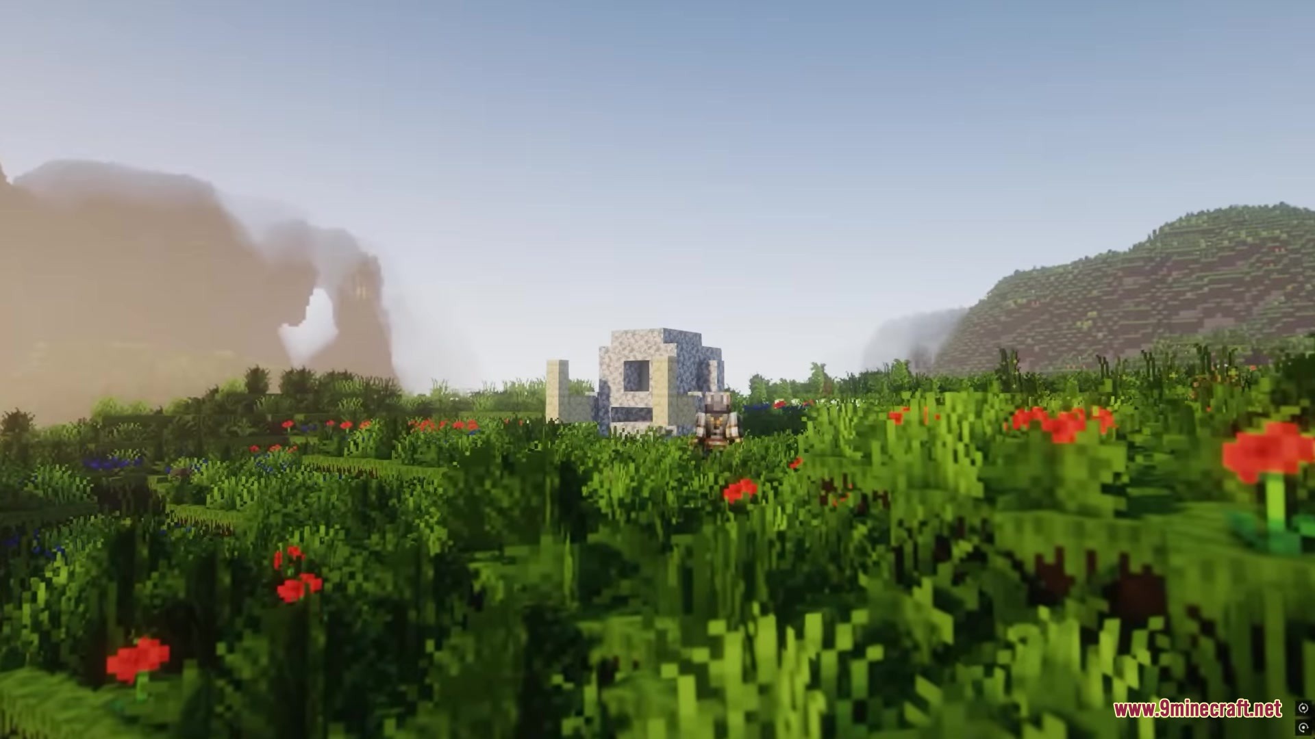 A stone Riftstone structure sits in a field of flowers and grass