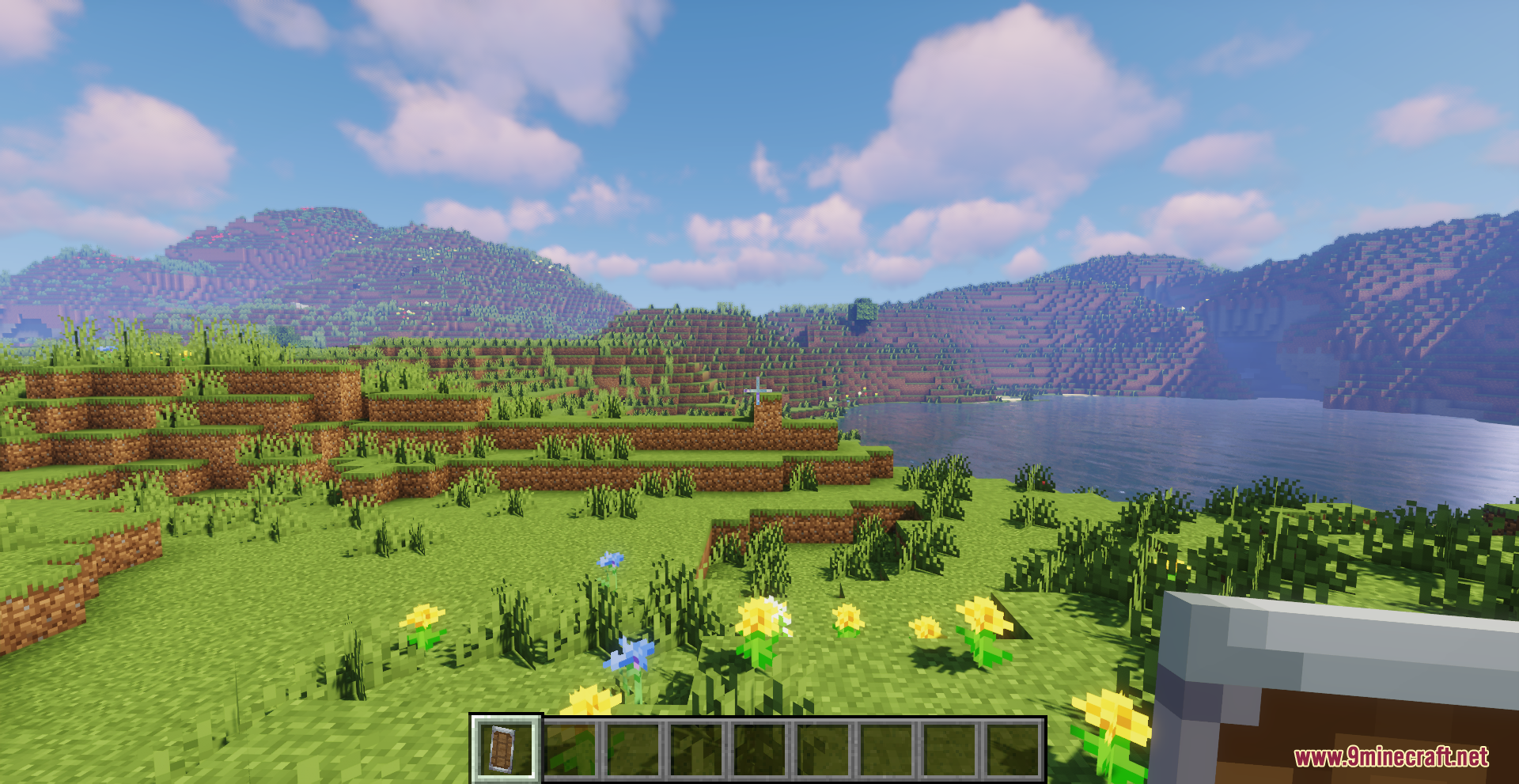 Drodi's Shield Resource Pack Screenshot 2 A player holds a smaller shield while looking at the landscape