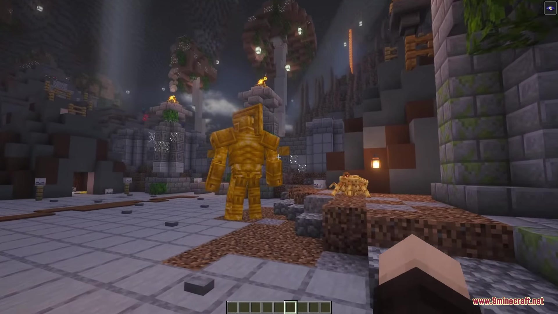 A giant golden Dwarven Centurion stands in a stone ruin with a spider