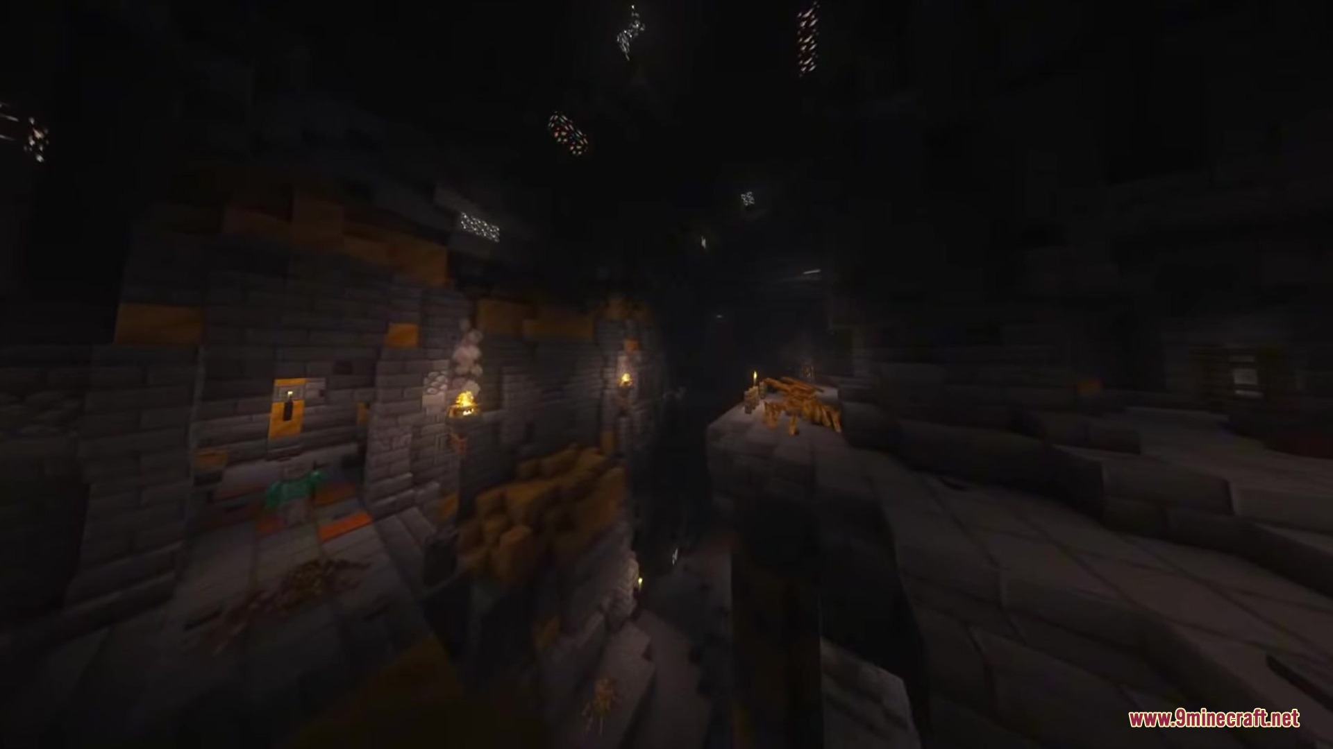 A golden mechanical spider rests on a stone ledge inside a dark cave