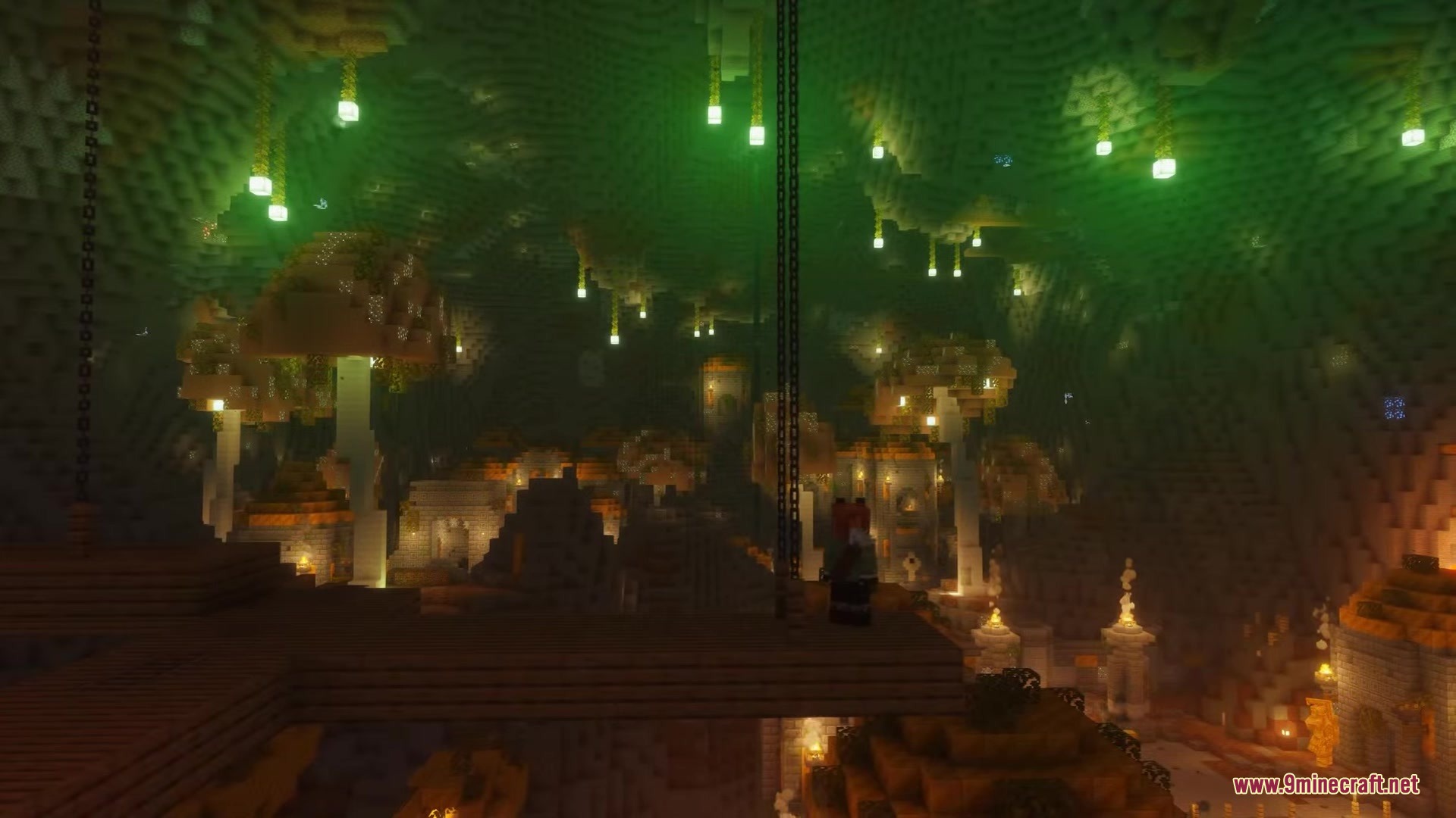 Giant glowing mushrooms and ancient ruins fill a massive underground cave system
