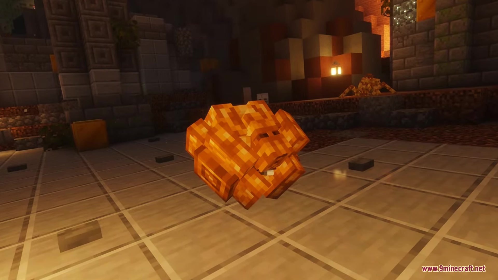 A golden mechanical sphere sits on the floor of an ancient stone ruin