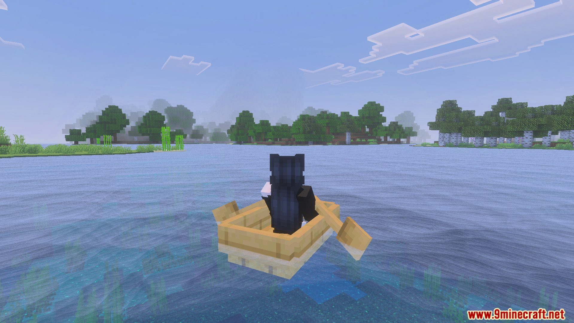 Player rowing a wooden boat on clear blue water near a forest