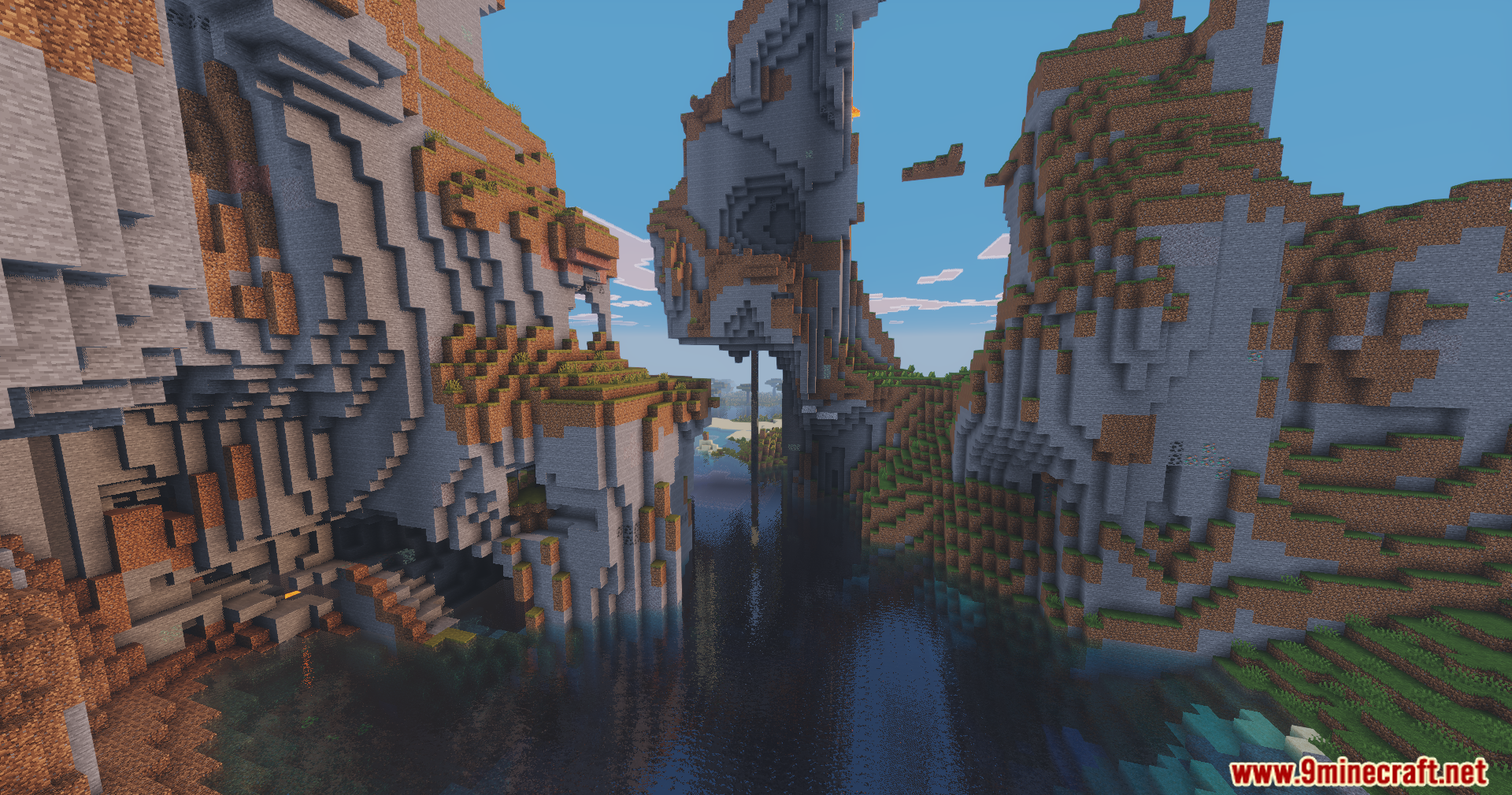 Jagged mountains surrounding a narrow water passage under a bright and colorful sky