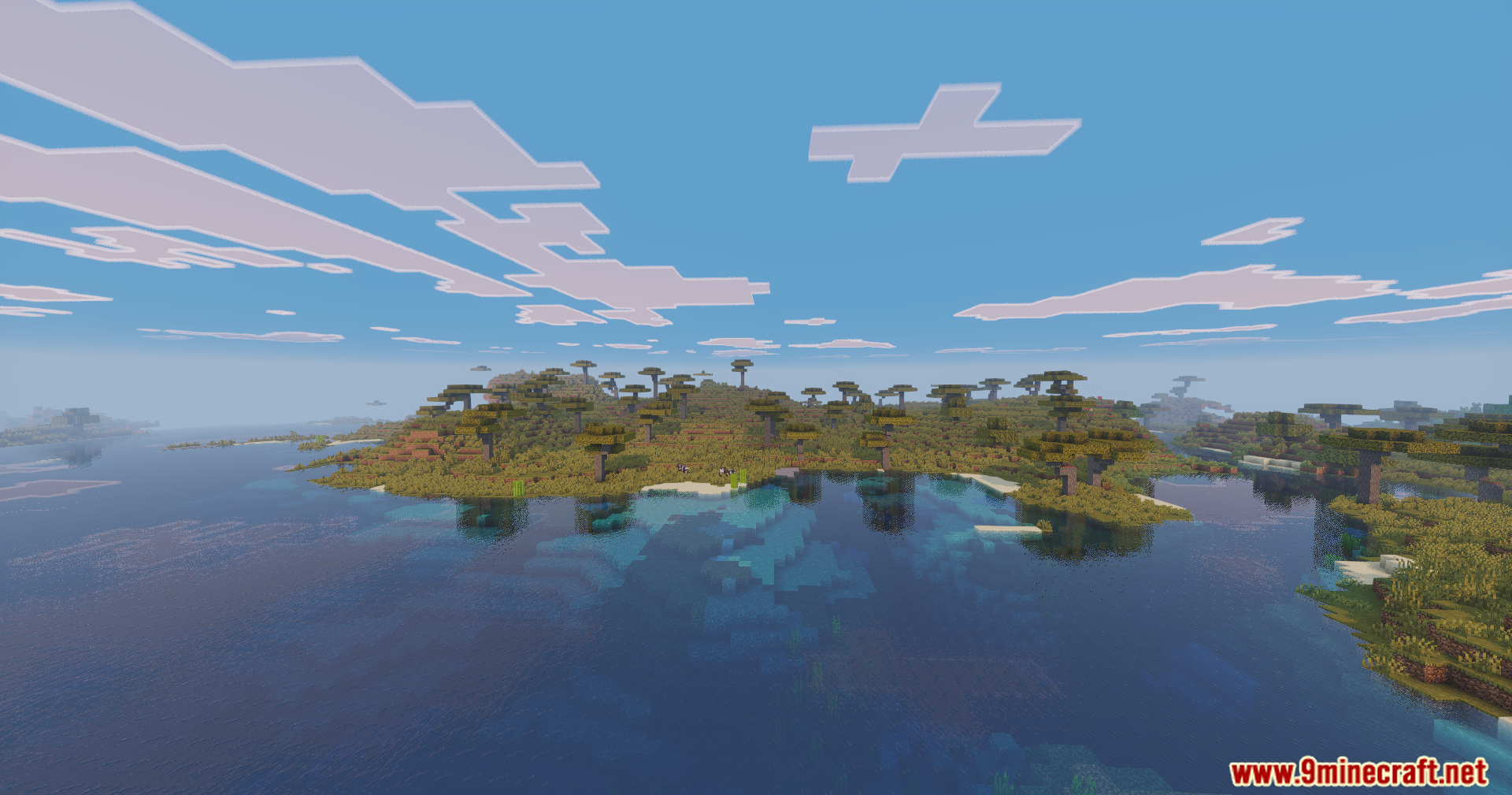 Wide view of a savanna island with vibrant colors and clear water reflections