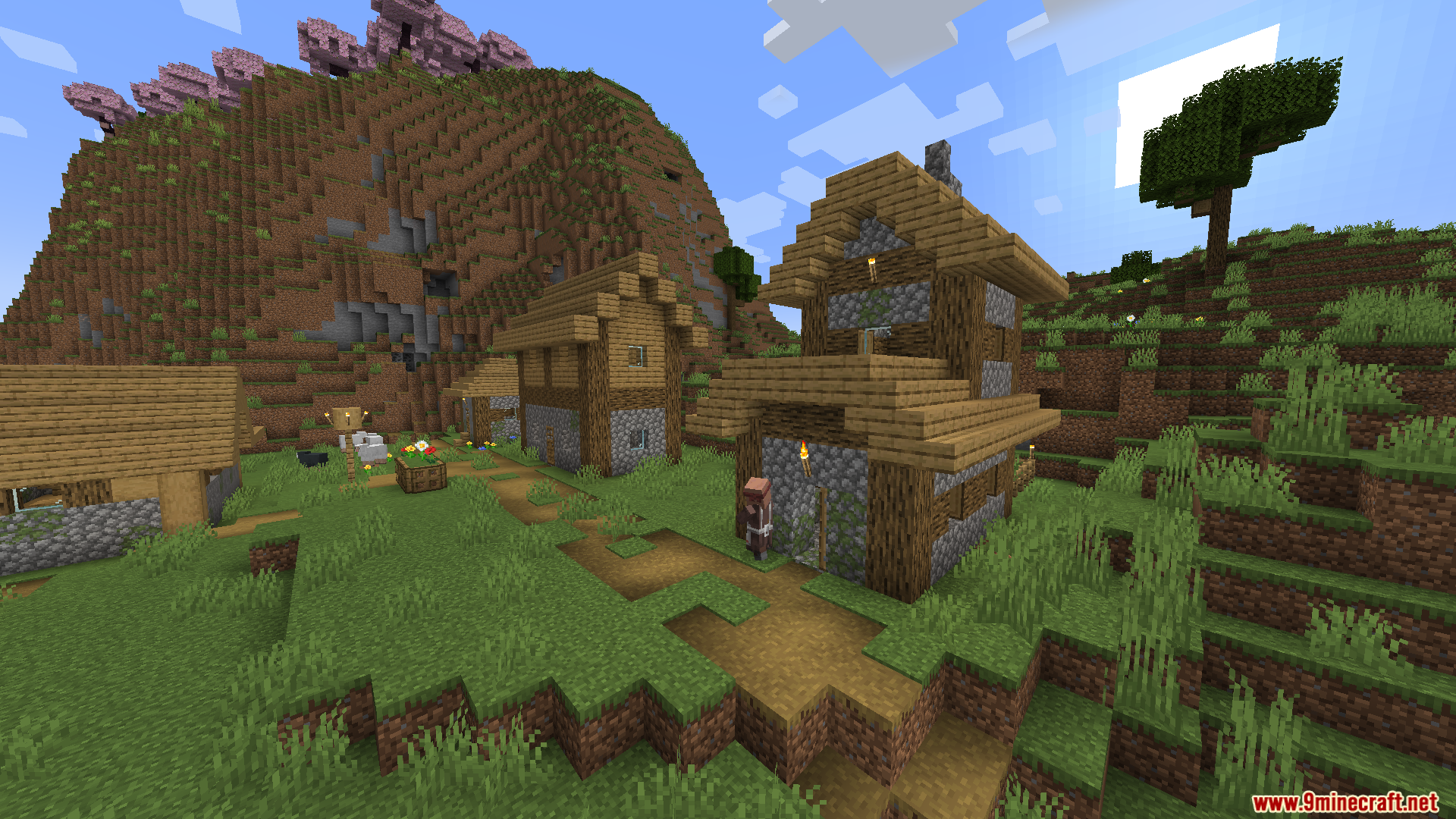 Enough Visuals Mod Screenshot 6 A villager standing on a path near houses with a cherry blossom mountain