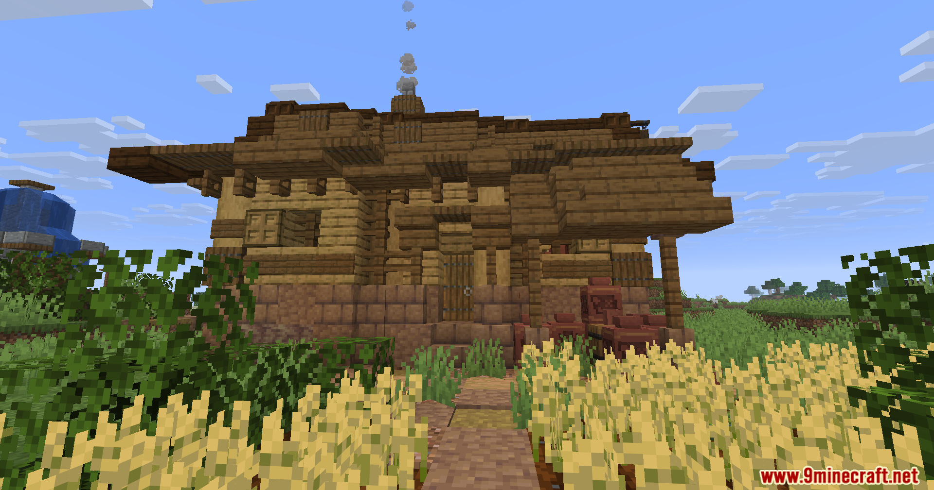 Epic Structures Villages Mod Screenshot 12 A large wooden house with a complex roof and a wheat field